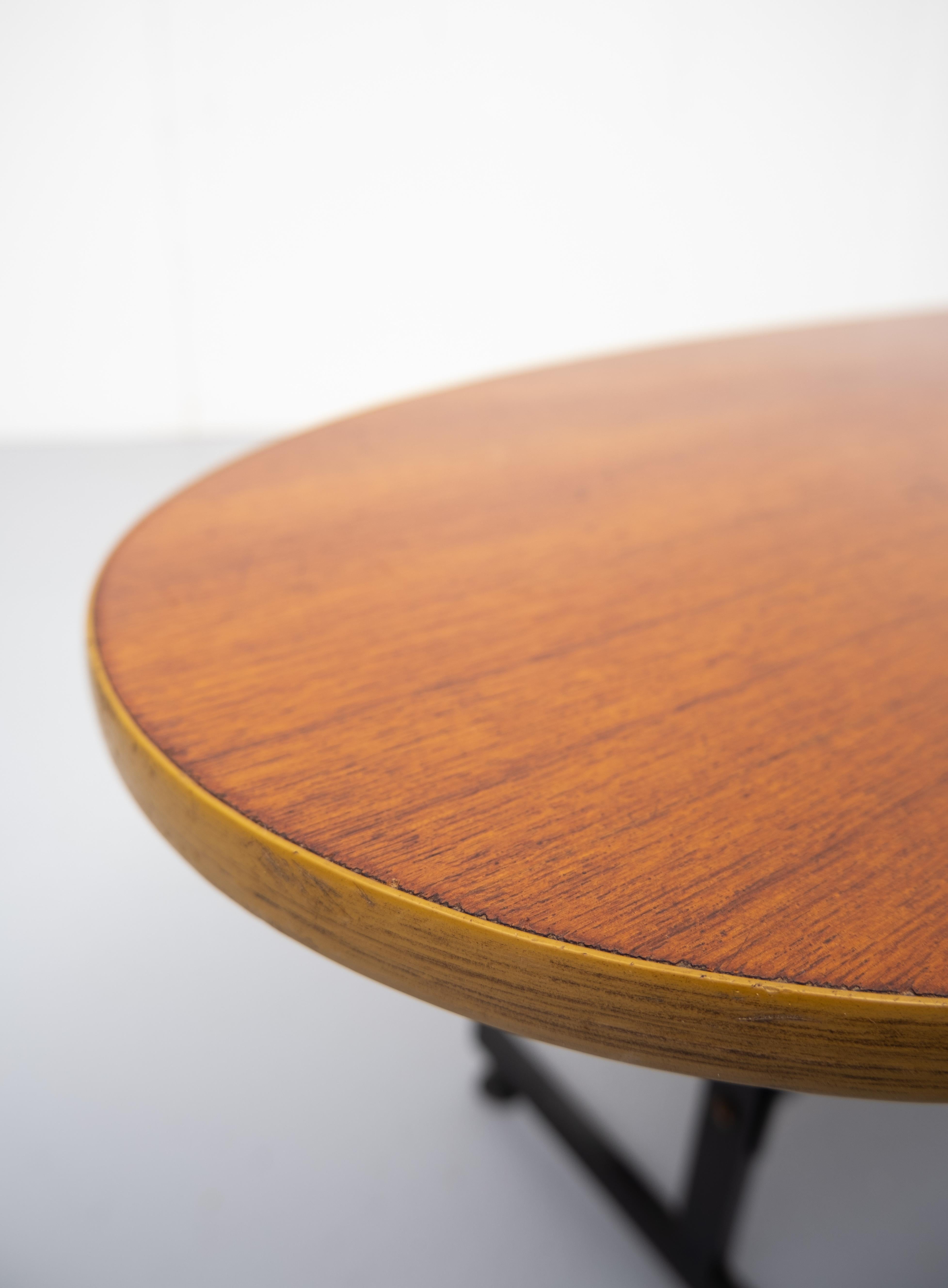 Teak coffee table. Oval Shaped like a small surfboard. Metal legs, comes with adjustable feet.
1950s.