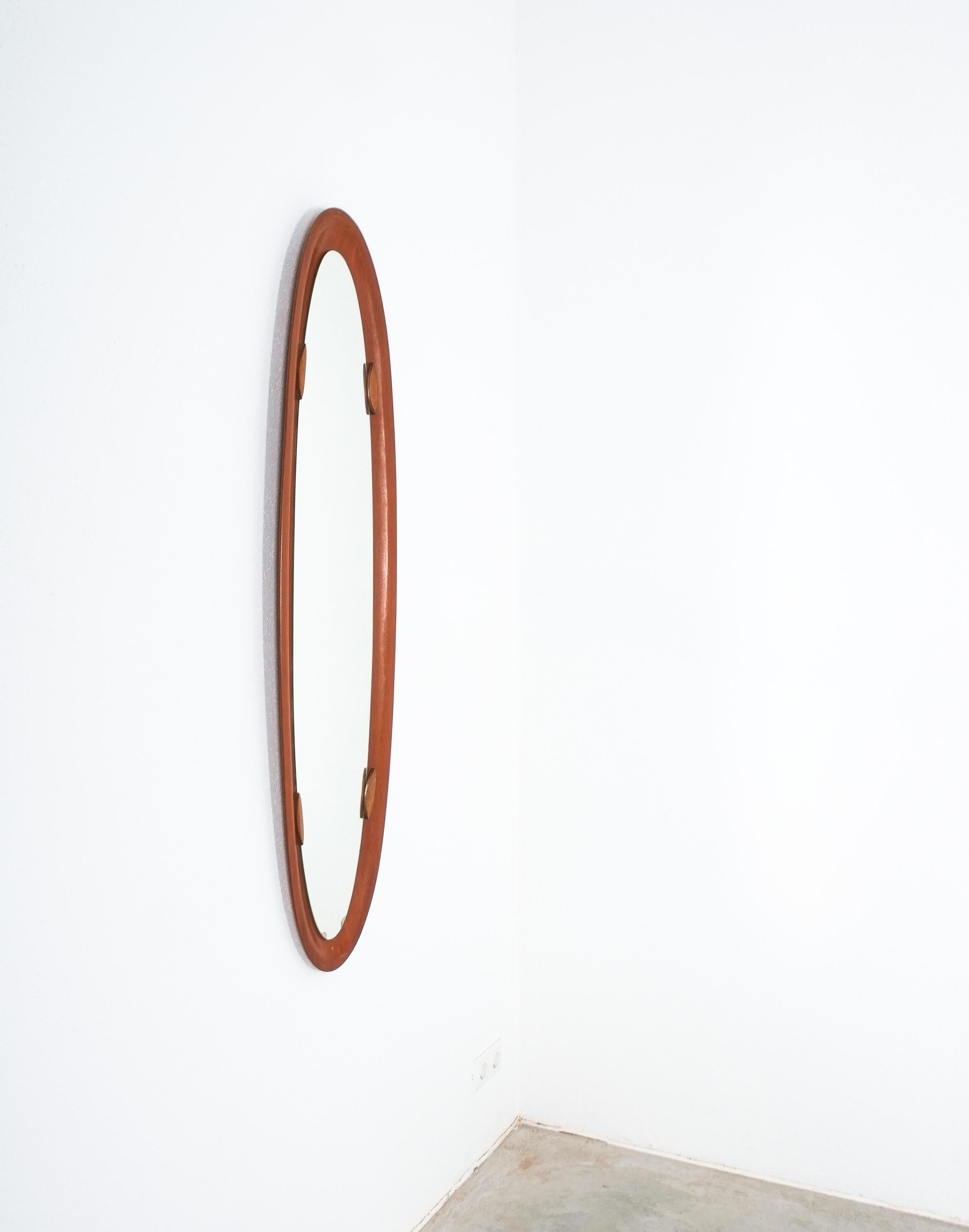 Slender surfboard shaped teak veneer mirror, Italy, circa 1950

Full size mirror with 55