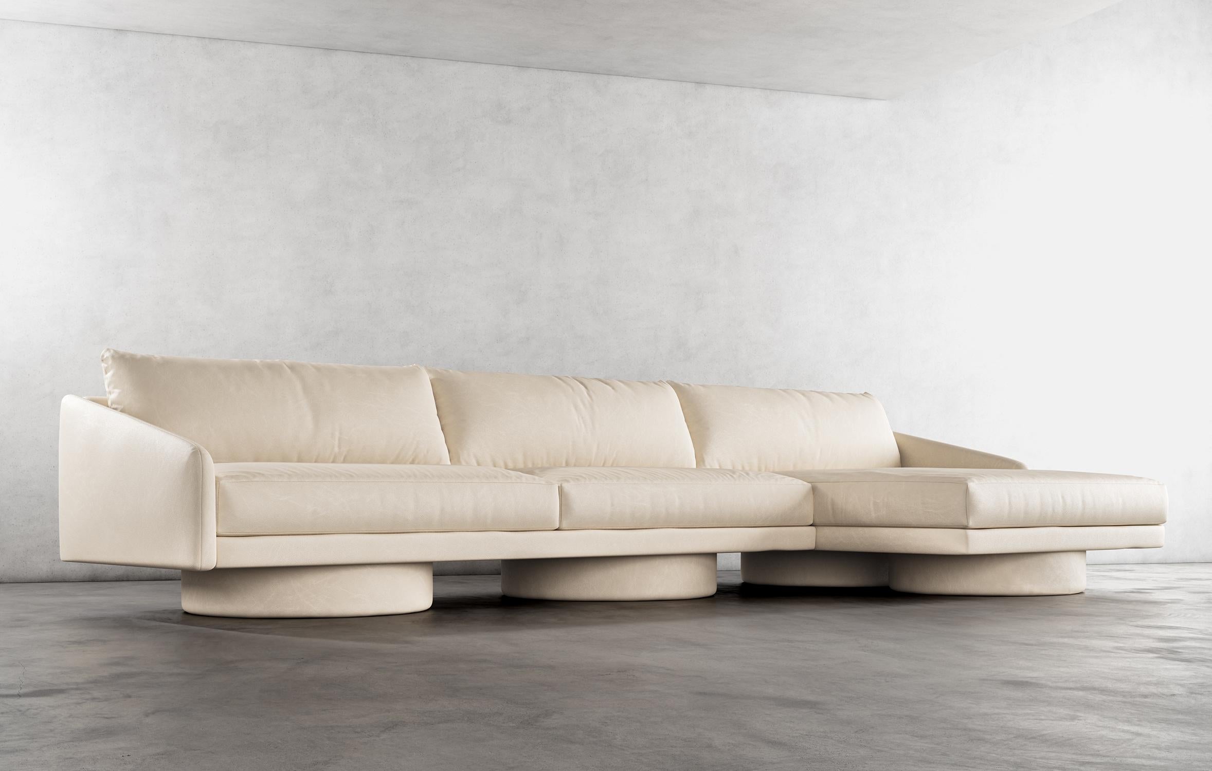 SURGE SECTIONAL - Modern Sectional Sofa in Cream Faux Leather

The Surge Sectional Sofa in cream faux leather is a luxurious and stylish piece of furniture that is perfect for any modern living room. This sectional features a sleek design with clean