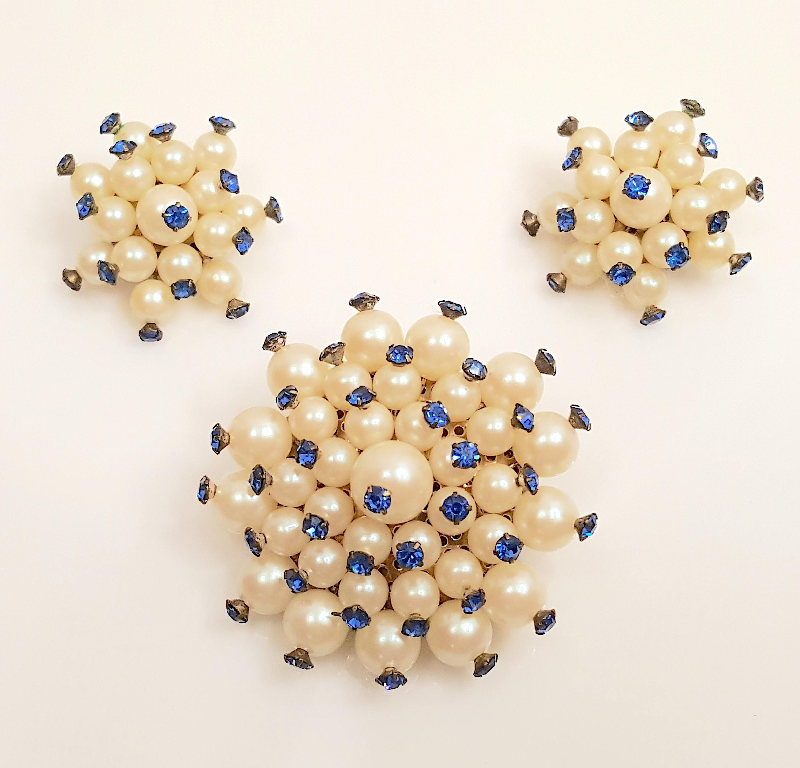 This surrealistic handcrafted faux-sapphire-topped-pearl cluster brooch and clip-earrings set dates to around WWII, when fashion designer Elsa Schiaparelli (1890-1973) embraced the art-movement Surrealism and relocated from Paris to New York while