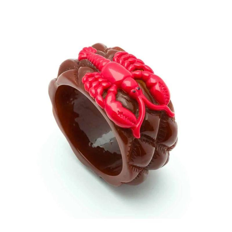 So surreal, Schiaparelli & Dali together with this very unique vintage lobster bangle made of red & brown bakelite. c.1950. 

Unsigned, just unique !!!
Size : Inside diameter : 6.2 cm, Width : 4 cm
Condition : Very good vintage condition (no