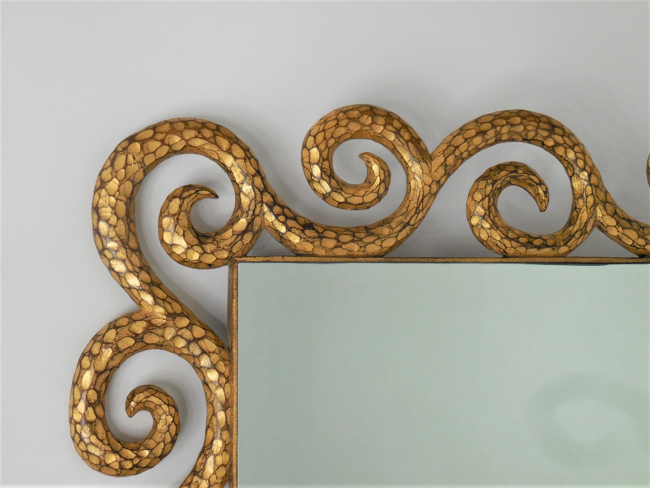 A large carved wood mirror in the surreal style of Garouste and Bonetti. The carved scrolling element has an organic feel that brings to mind baroque creations but presented in a definitely modern and fresh manner. Includes hanging mechanisms for
