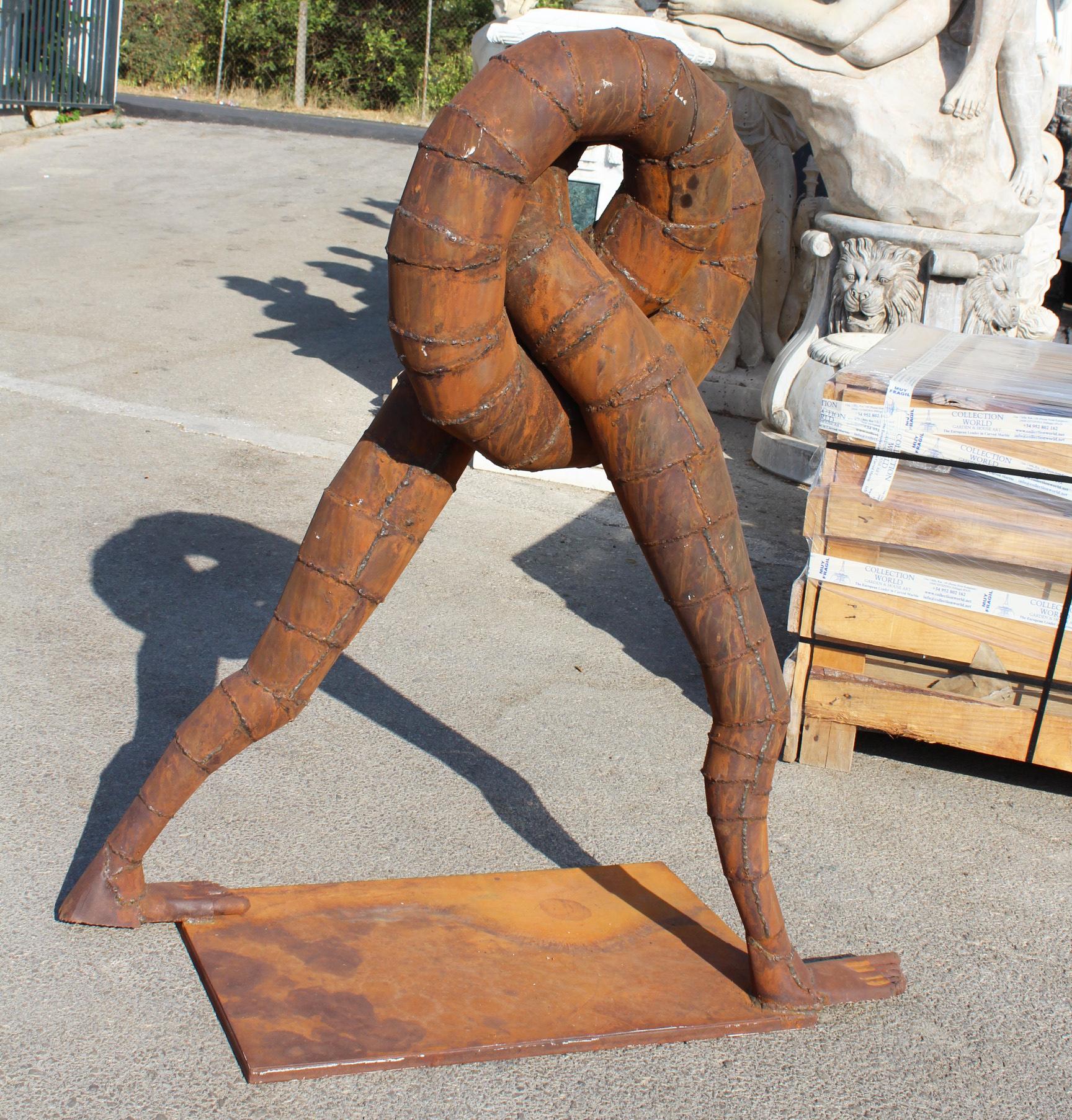 Surrealist iron sculpture where intertwined legs form the body.
