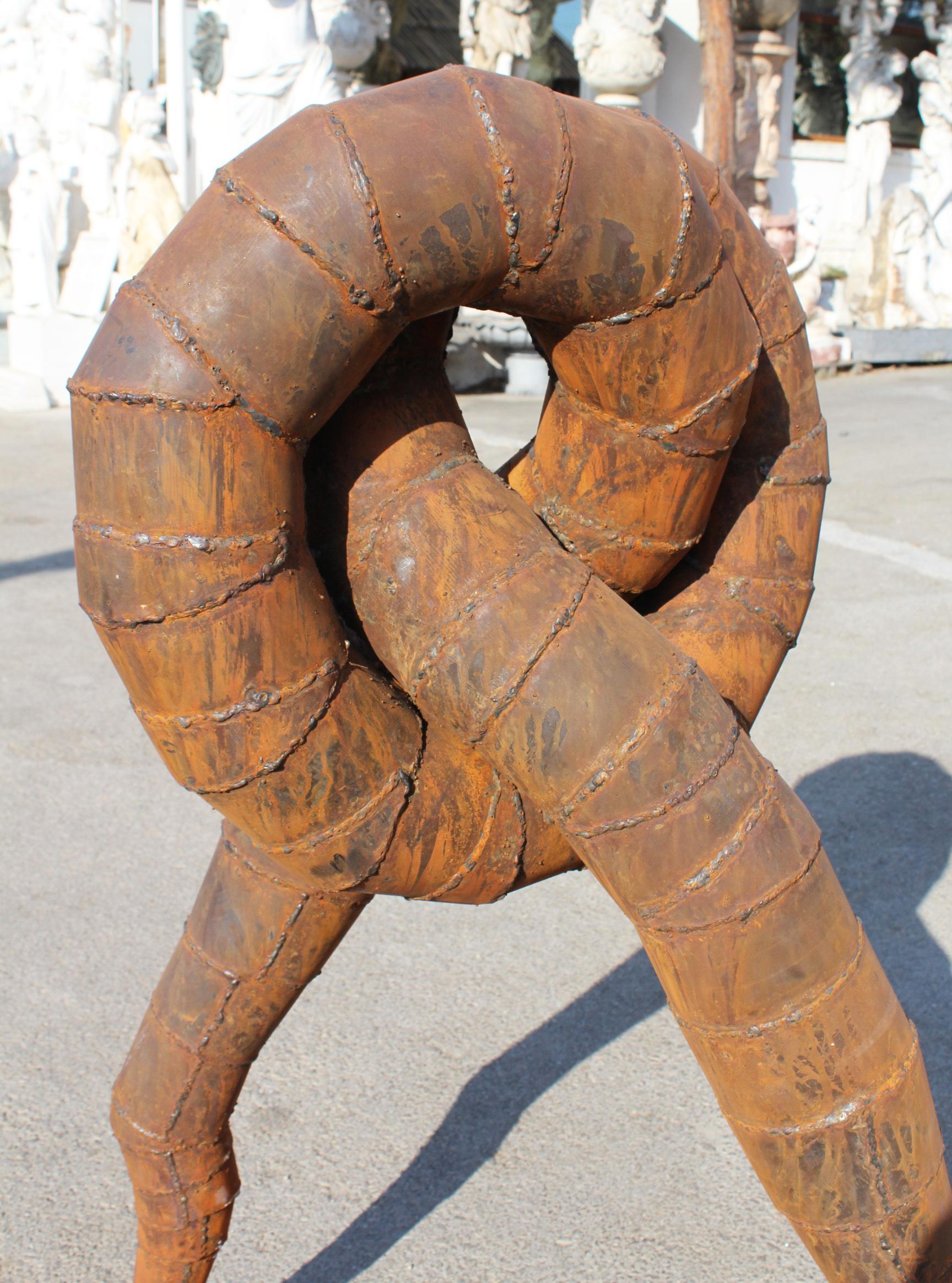 Contemporary Surrealist Iron Sculpture Where Intertwined Legs Form the Body