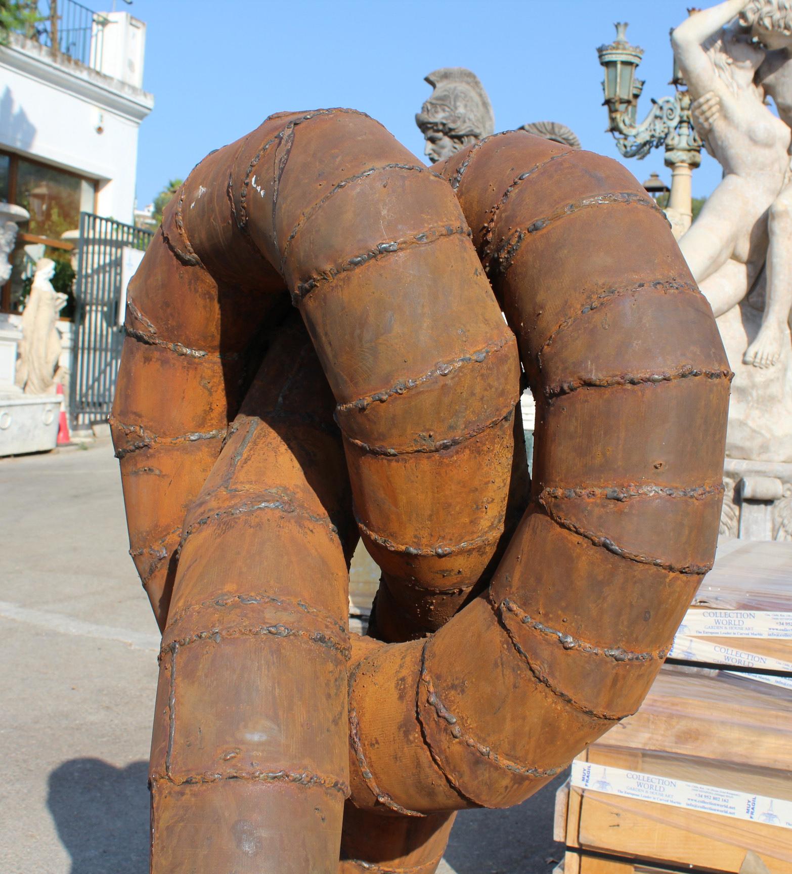 Surrealist Iron Sculpture Where Intertwined Legs Form the Body 1