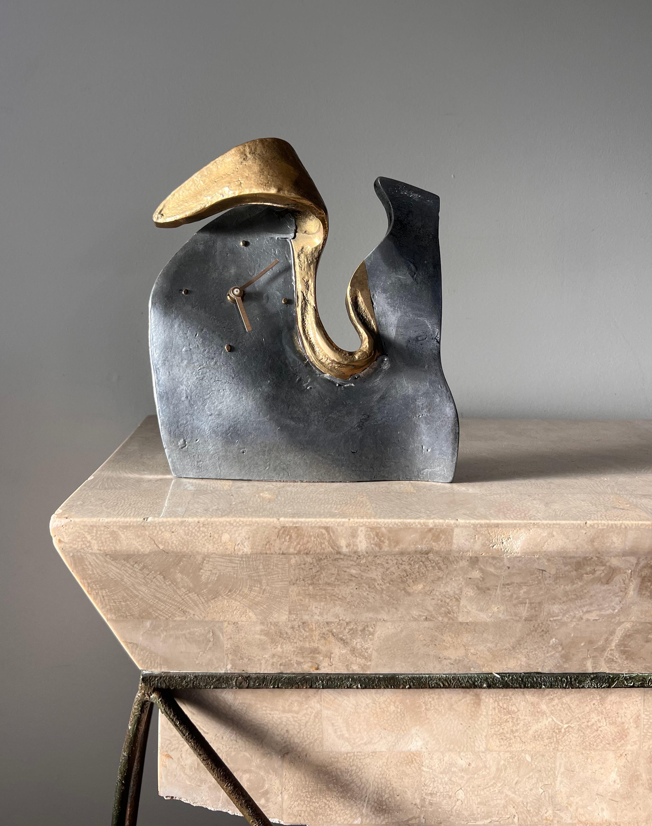 An incredibly rare brutalist / surrealist clock in bronze and aluminum by David Marshall for Art3, Spain circa 1970. From the Moroccan estate of a private collector. “Melting” edges give the clock a decidedly Dali-esque edge, while the metallic