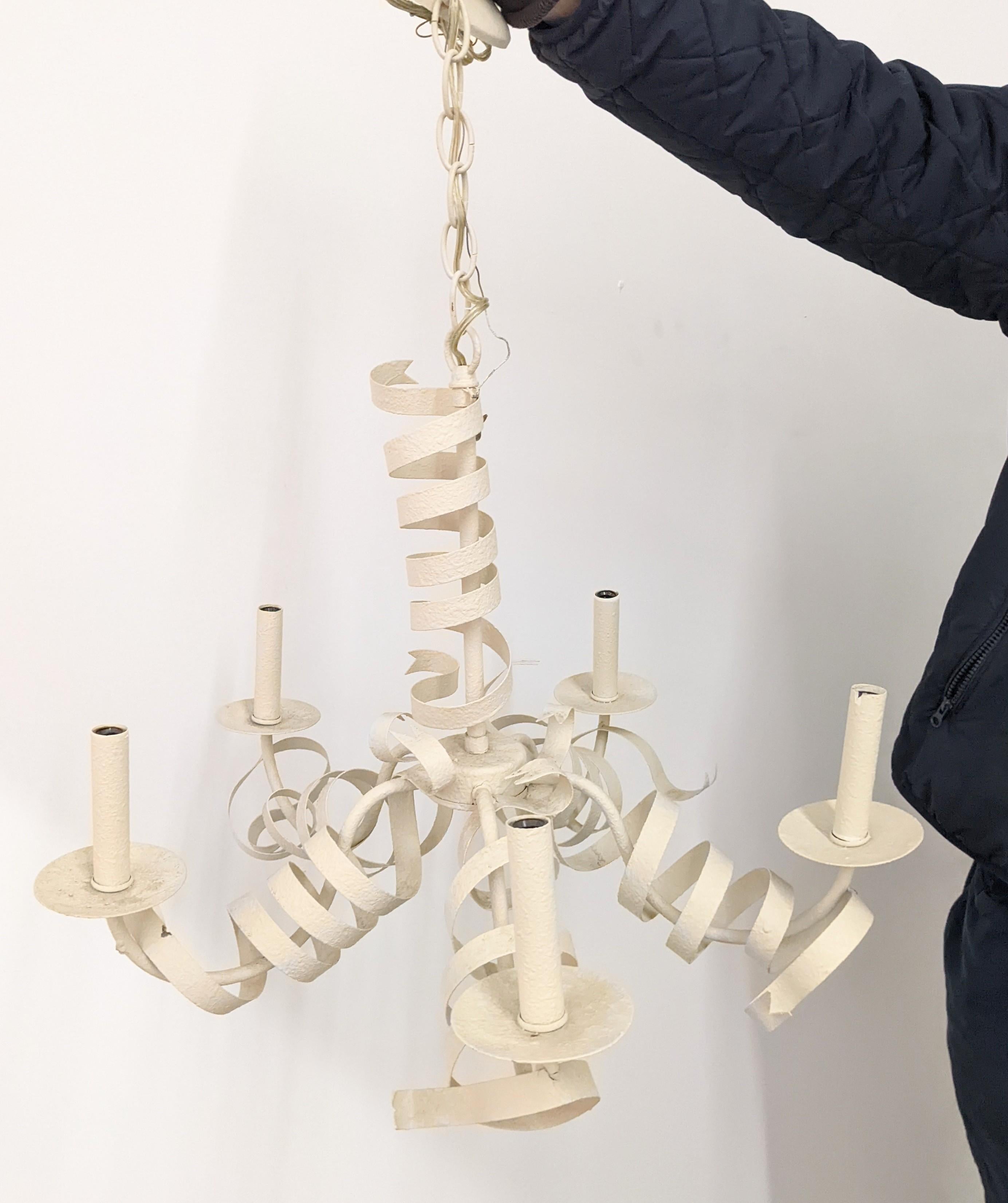 Charming painted metal chandelier in the Surrealist style with spirals of metal ribbons wrapped around the fixture. Finish is a pebbly enamel in a chalky ivory white. 
Measure: Width 23