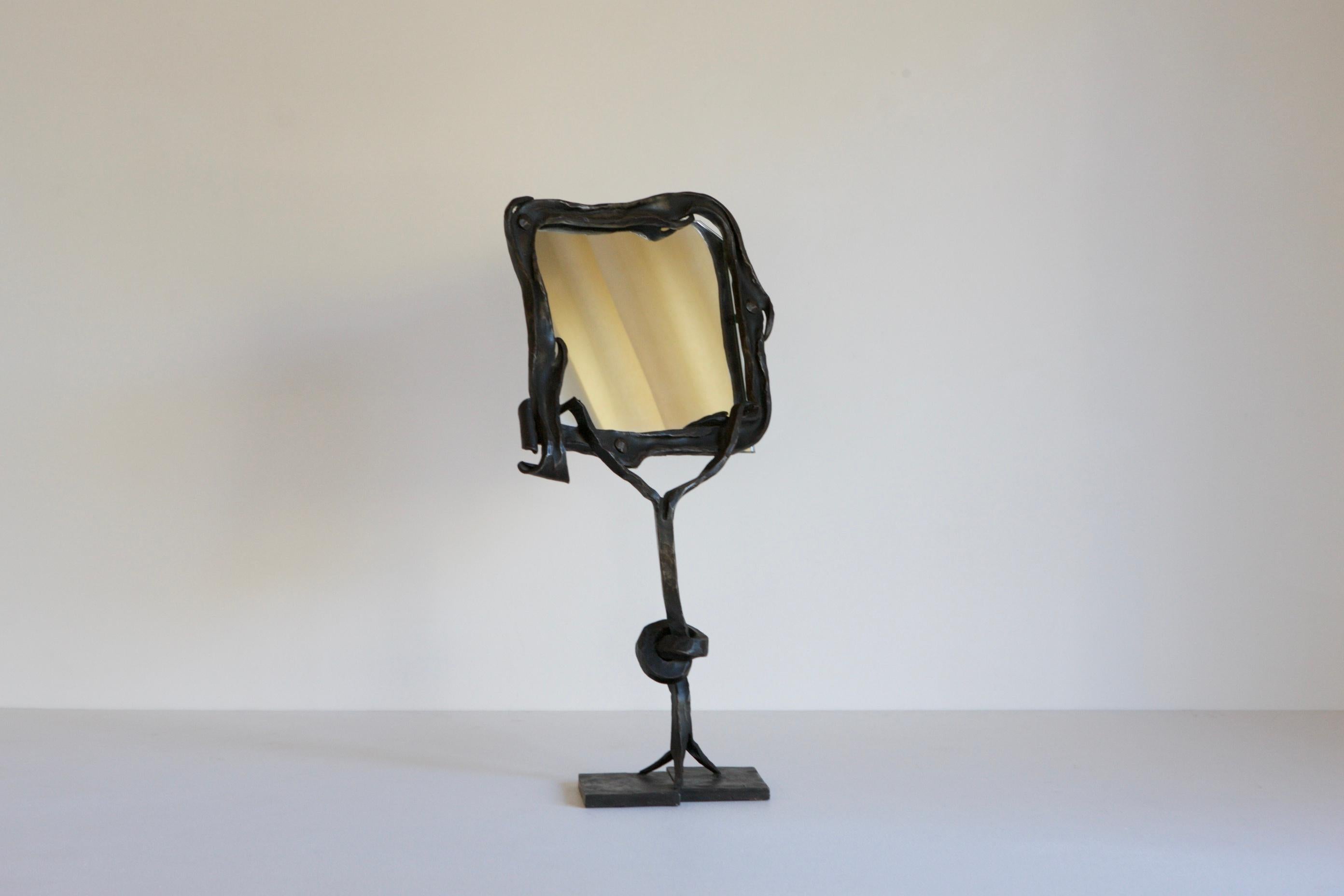 An exceptional table mirror with a surrealist feel. The piece is handmade with wrought iron and stands alone.