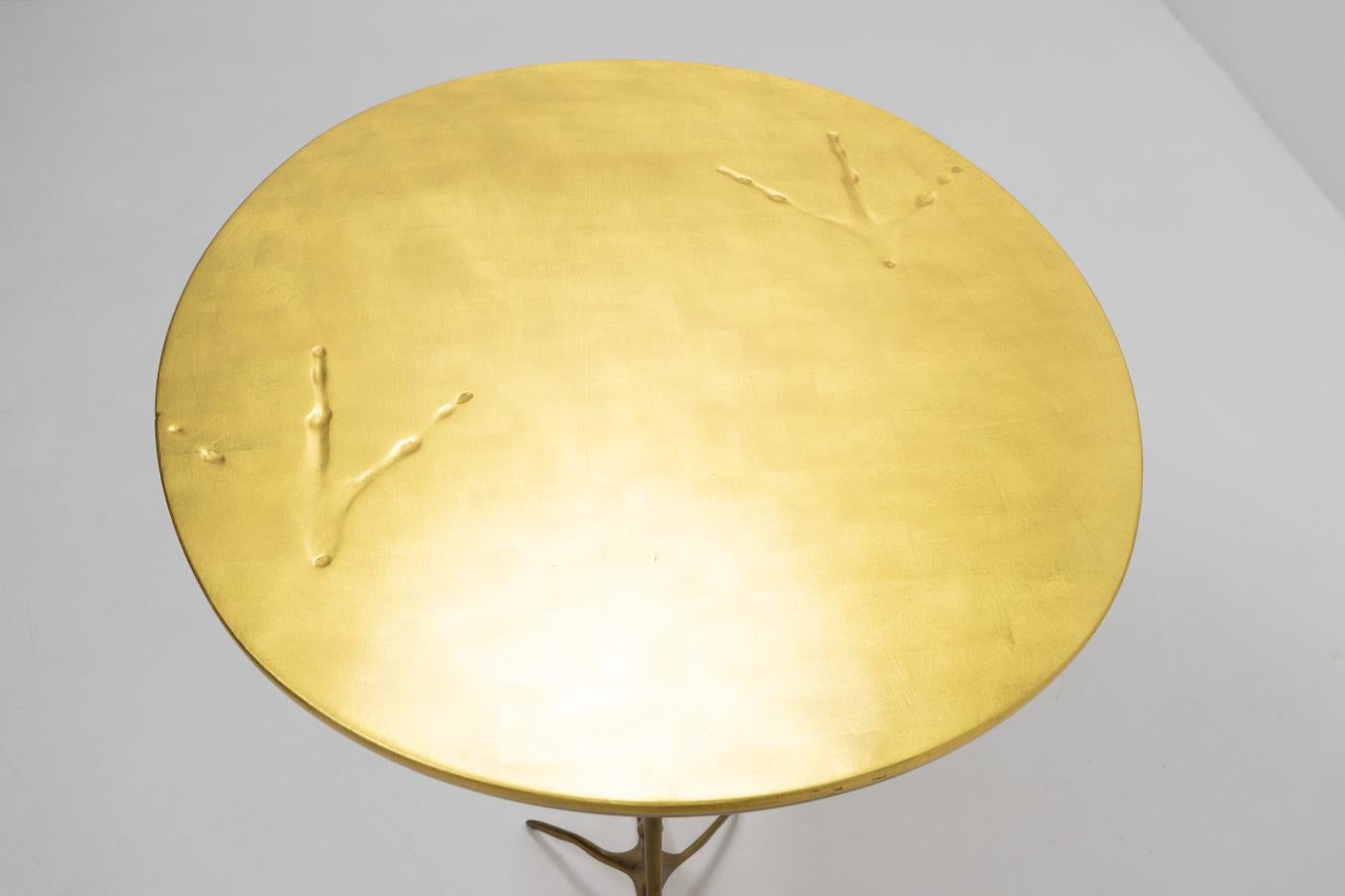 The Traccia (“Trace”) side or coffee table was designed by artist M�éret Oppenheim in 1939, representing a birdlike animal. The foot-printed, gold-leaf covered table top is in the shape of an egg, the solid cast bronze legs are those of a bird with