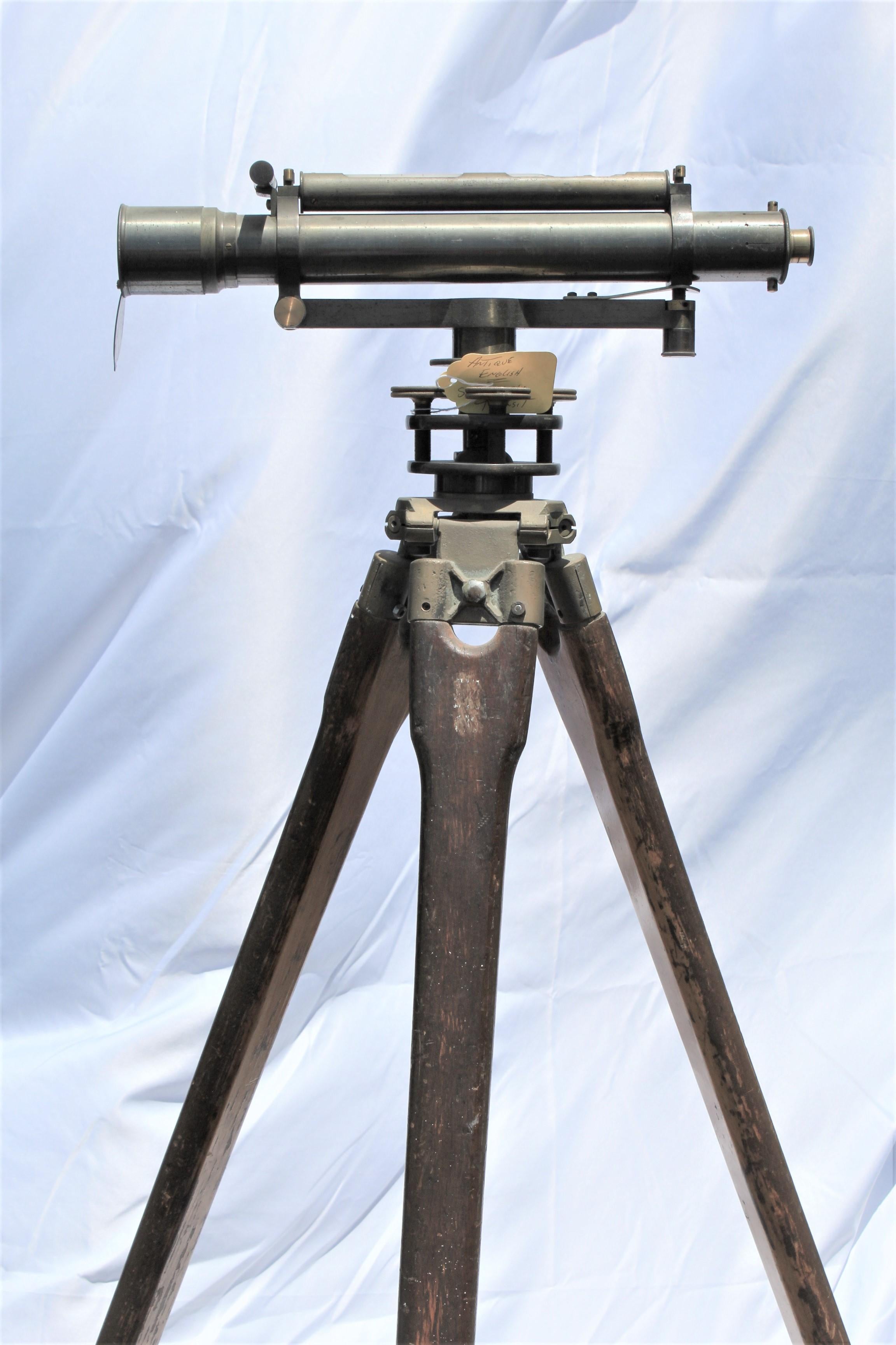 An old Surveyor's Transit from London. All brass and mounted on wood legs. Signed Troughton & Sims. London. All good except for the top glass cover. Could be replaced. Sort of heavy. At 66