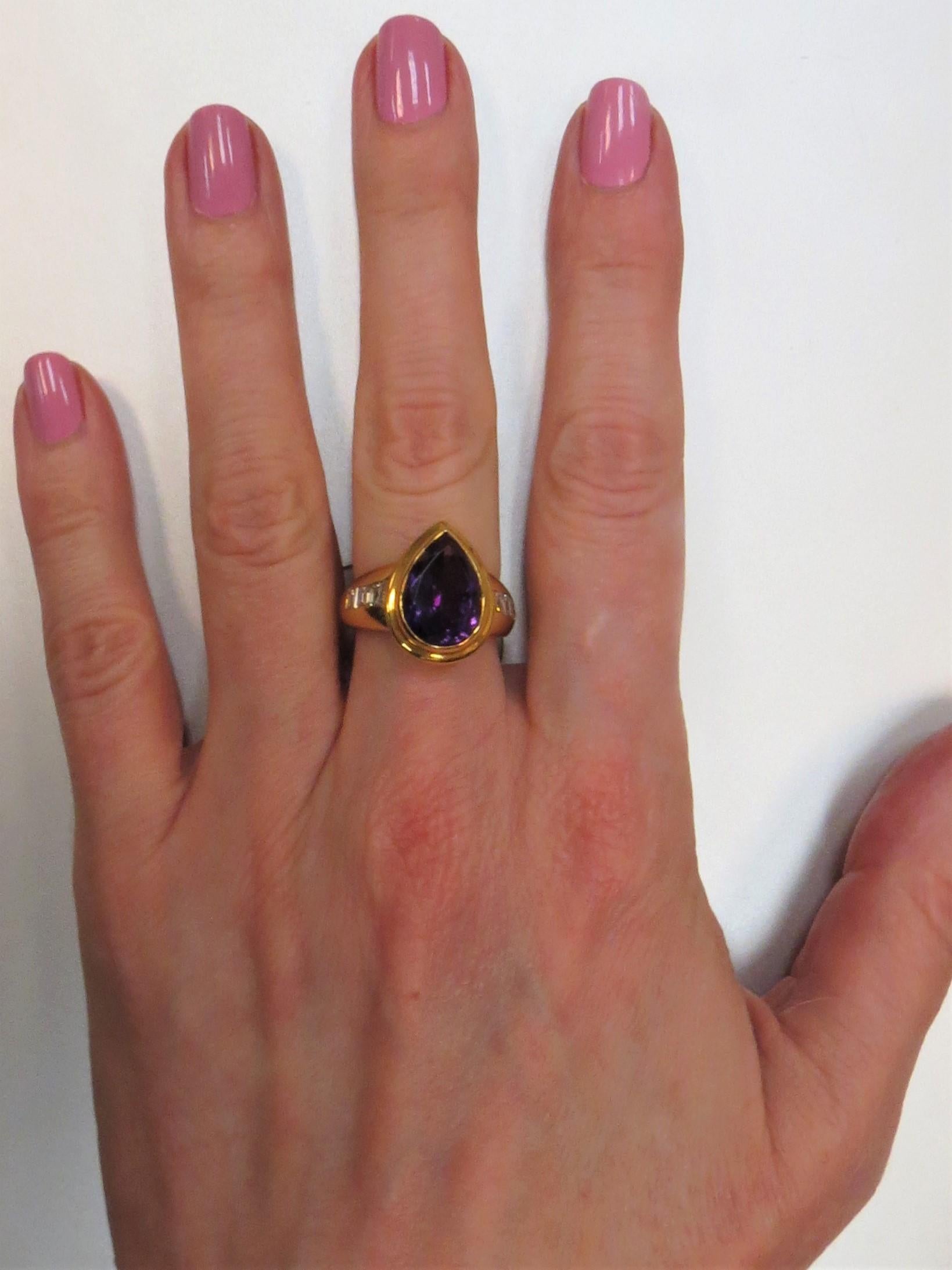 Susan Berman, 18K yellow gold ring, bezel set in center with one Pear shape Amethyst weighing 4.49ct and 6 Square cut diamonds weighing .72cts, G color, VS clarity. 
Finger size 6, may be sized. 
Retail $5500