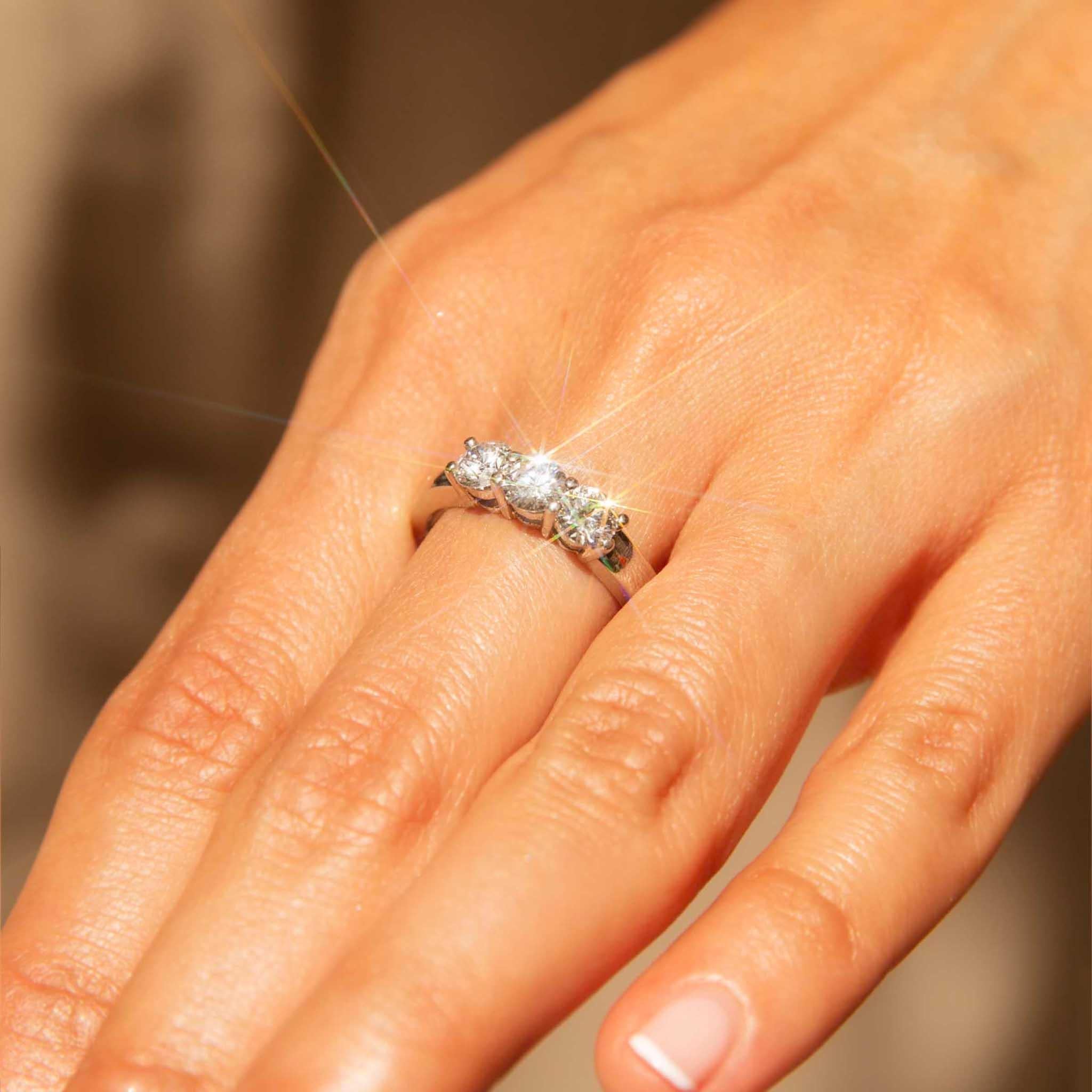 Our exquisite Susan Ring is set with a shimmering trio of diamonds in a platinum setting. Her three diamonds, each a radiant star, create a harmonious and elegant design. She is a symbol of love and commitment, a wearable piece of art that will