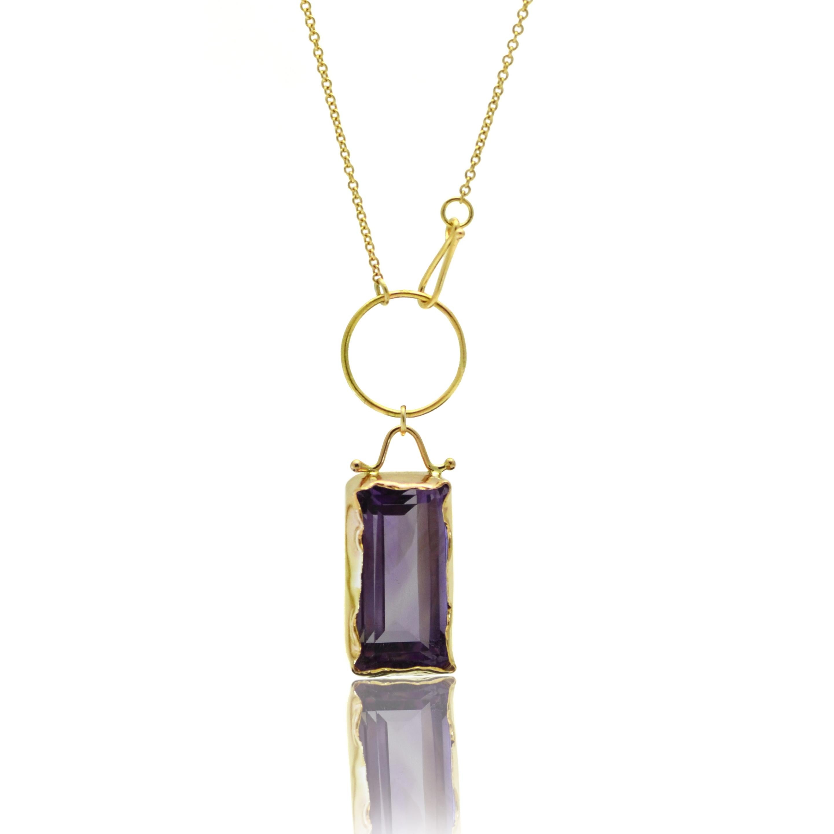 Hand fabricated from 14kt yellow gold by Susan Crow, the Amethyst and Yellow Gold Lariat Pendant is a one-of-a-kind piece that offers heirloom quality to your jewelry collection. The large 22ct emerald-cut Amethyst has a sensual exposed back setting