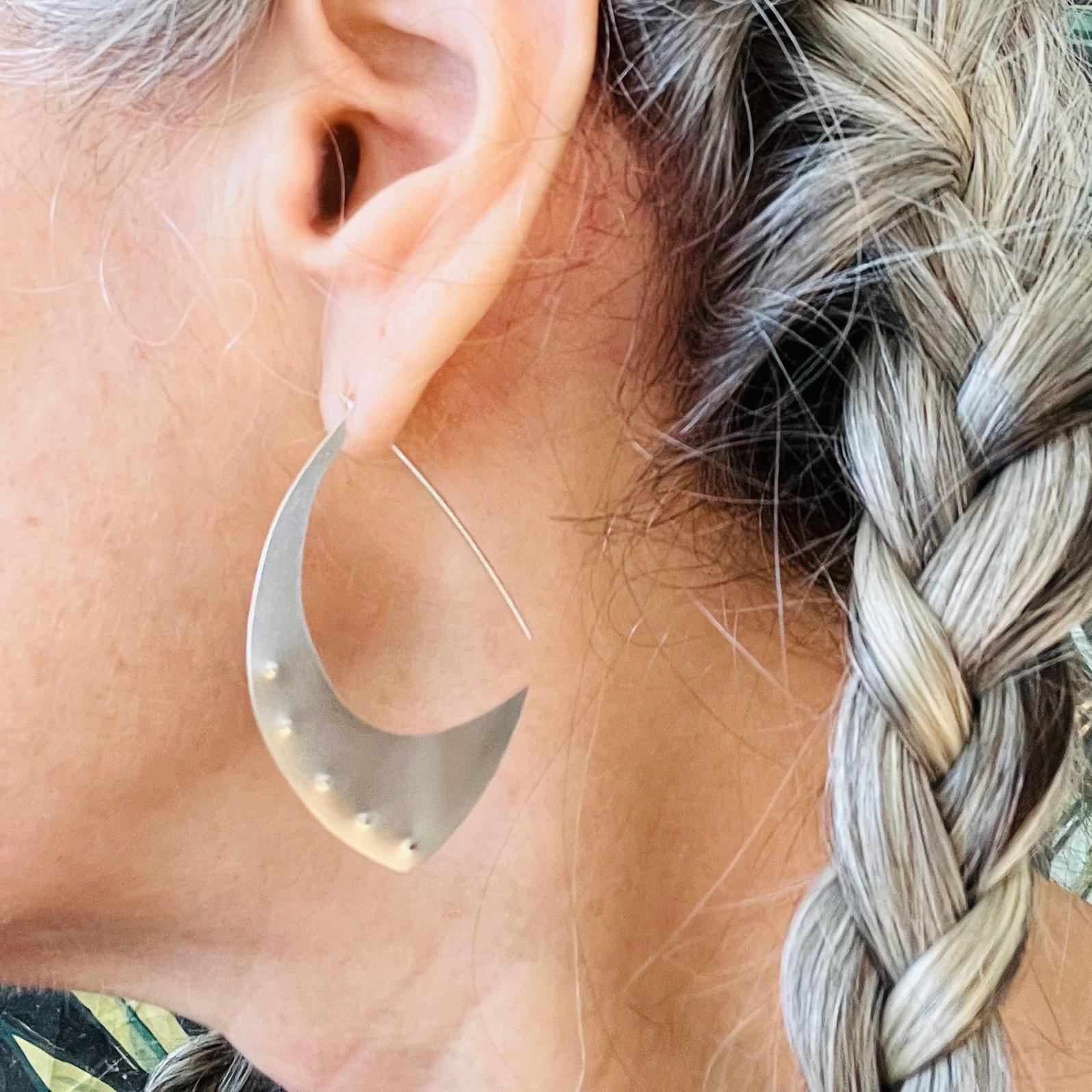 Hand fabricated jewelry means that the designer and maker Susan Crow actually made these earrings using sheet, wire and very specialized metal smithing tools to form the Aubergine Sterling Silver Hoop Earrings. They are the perfect size for everyday