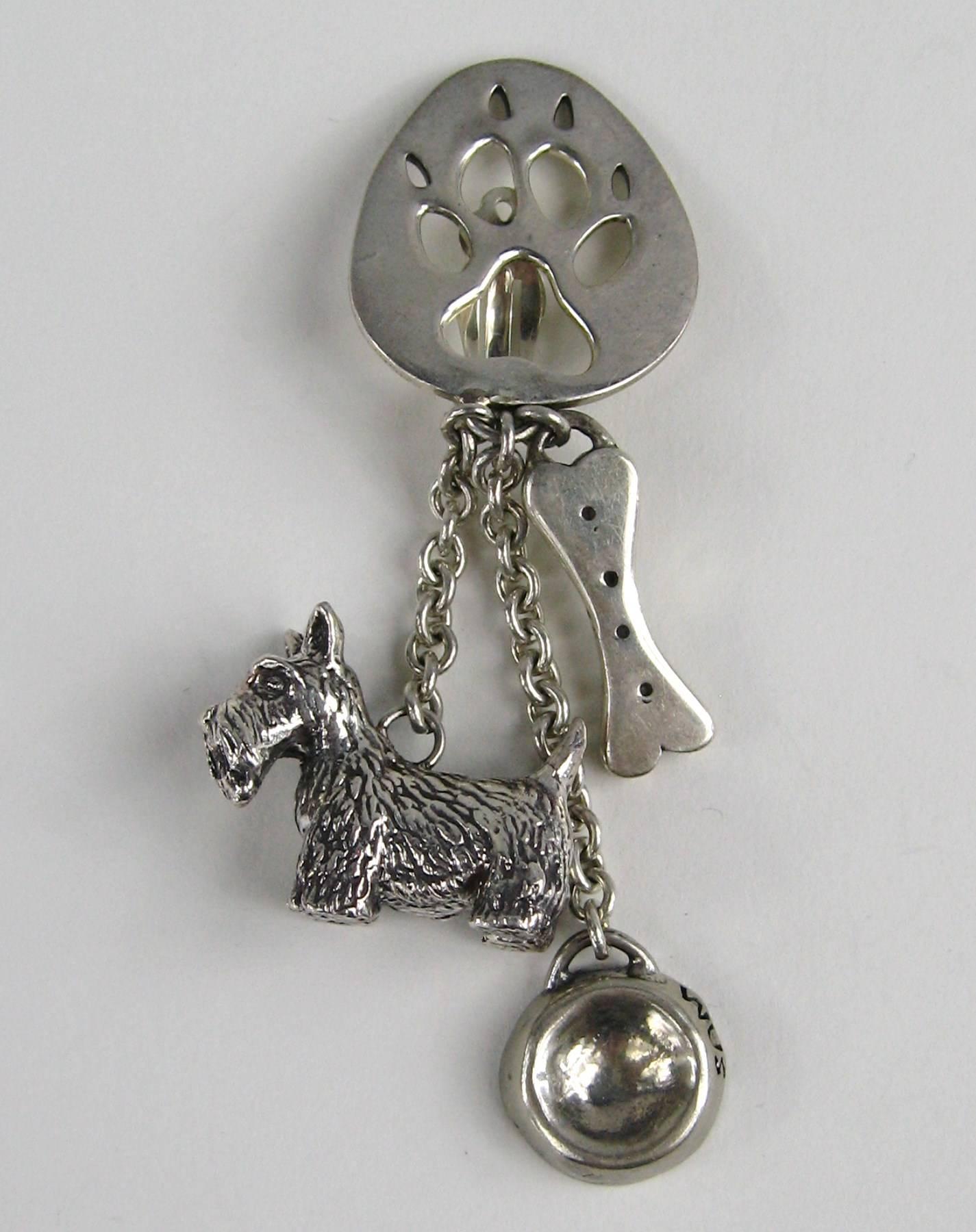 Susan Cummings adorable Dangle Clip on's earrings 3-D Dog along with a dog bone and bowl Measuring 3.25 inches long .84 wide on your ear lobe. There are more pieces of Cummings on our storefront. This is out of a massive collection of Hopi, Zuni,