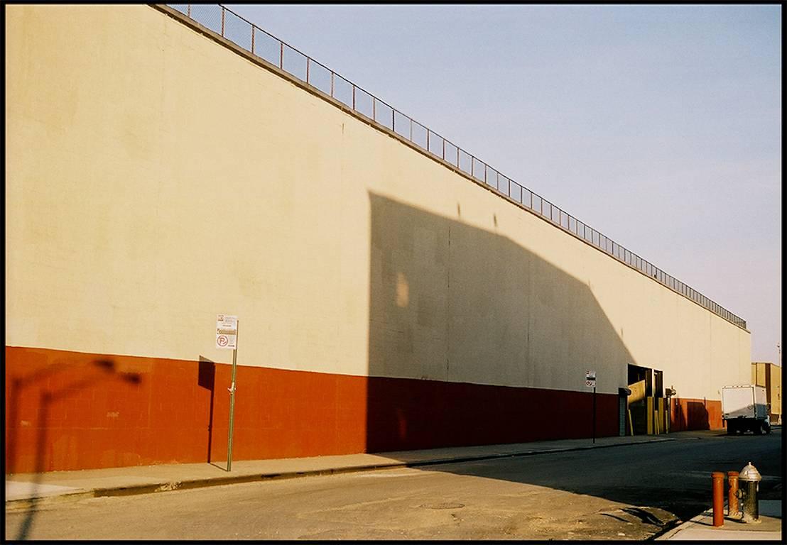 Williamsburg 24 is a contemporary urban color photograph by Susan Daboll. Daboll makes use of the borough's bold lines and colors to craft a thoughtful composition. 

SUSAN DABOLL is an American artist who has worked in a variety of mediums over the
