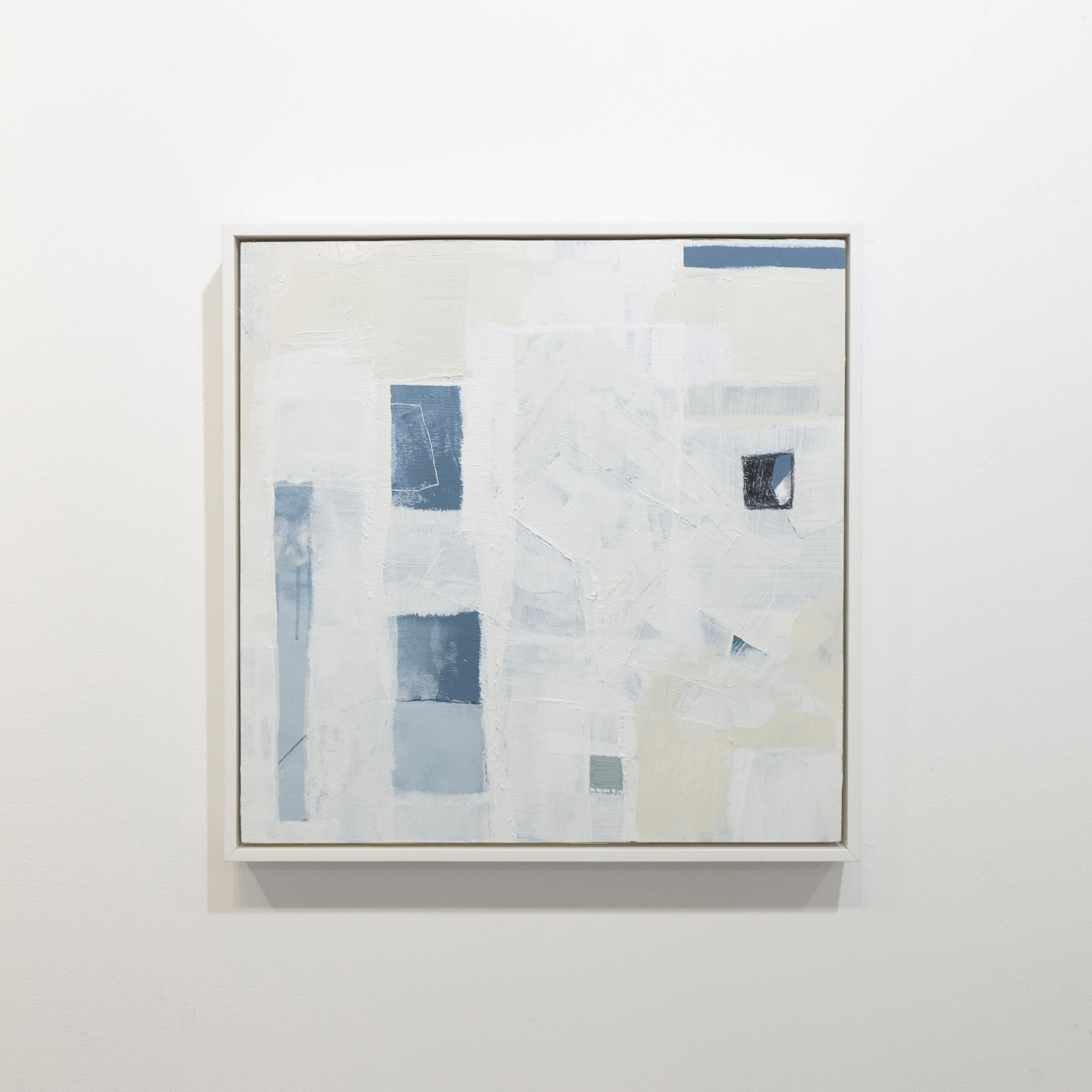 This abstract painting by Sue De Chiara is made with acrylic paint on panel. It features a light blue, white, and off-white palette, with a layered, minimalist composition. The painting is professionally framed in a white floater frame, and measures