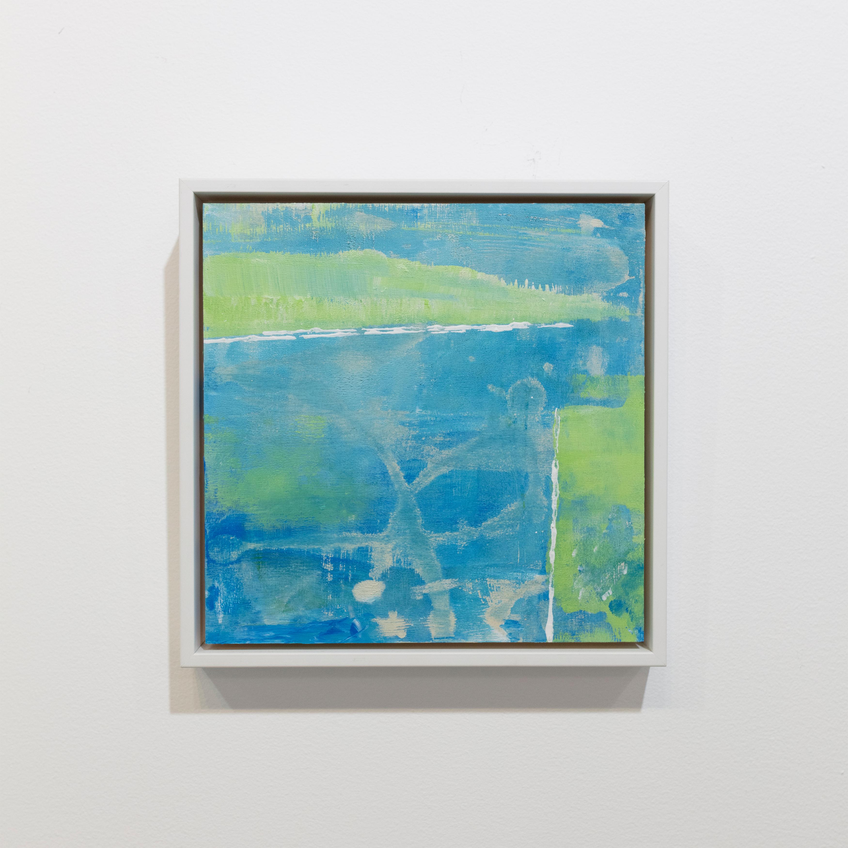 This small abstract painting by Sue De Chiara is made with acrylic paint on board. It features a blue, teal, and green palette and a layered, minimalist composition. The painting is professionally framed in a white floater frame. It measures 8" x