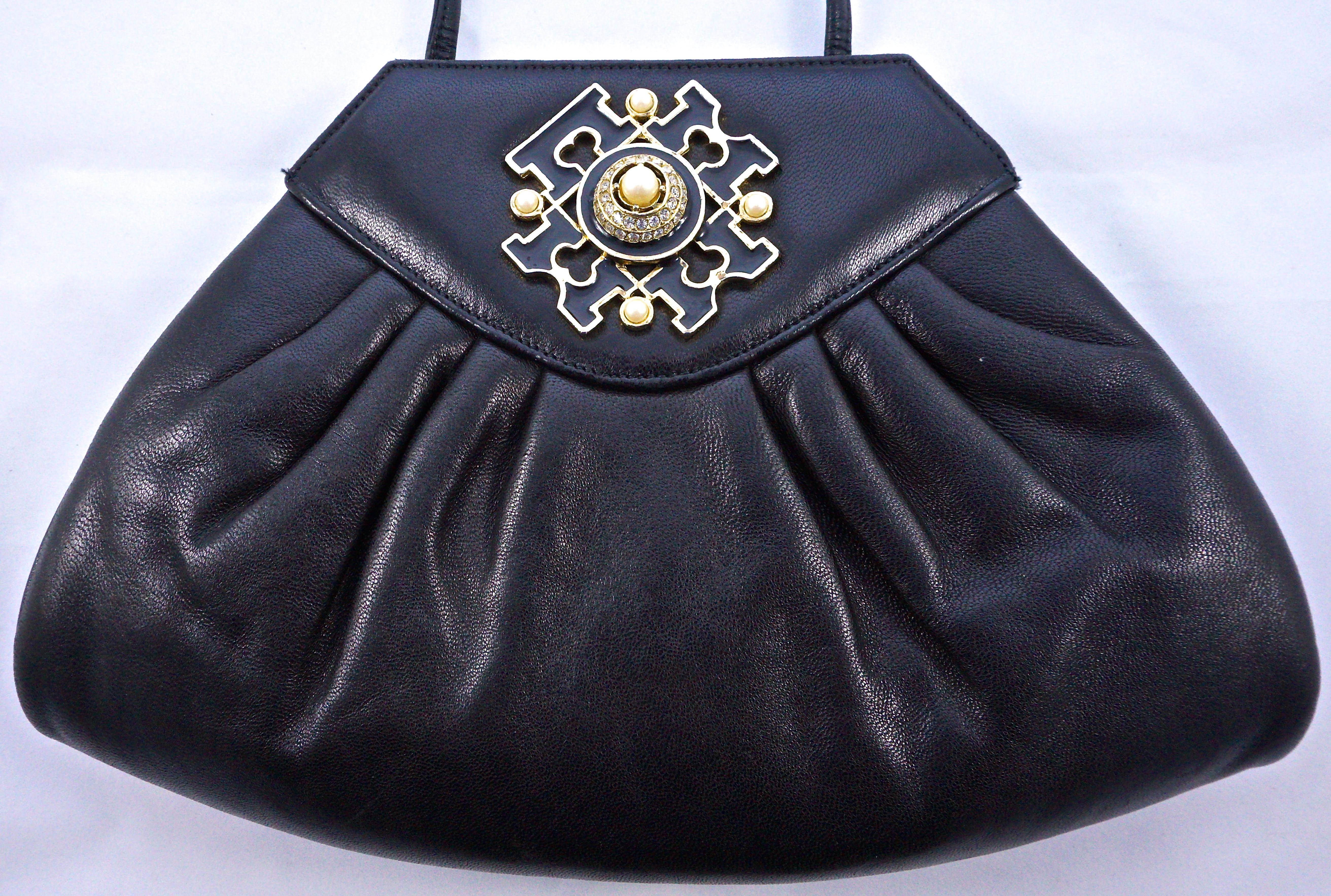 Susan Gail soft black leather shoulder bag. Measuring maximum length 28cm / 11 inches at the base, height 18.5cm / 7.28 inches, and maximum depth approximately 3cm / 1.18 inches. It has a lovely gold tone and black enamel design to the front, set