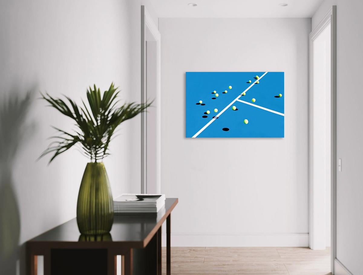 This contemporary photograph captures several green tennis balls bouncing on a blue tennis court, casting stark grey shadows as they are suspended in midair. The photograph is a metal sublimation print - this means the photograph is printed directly
