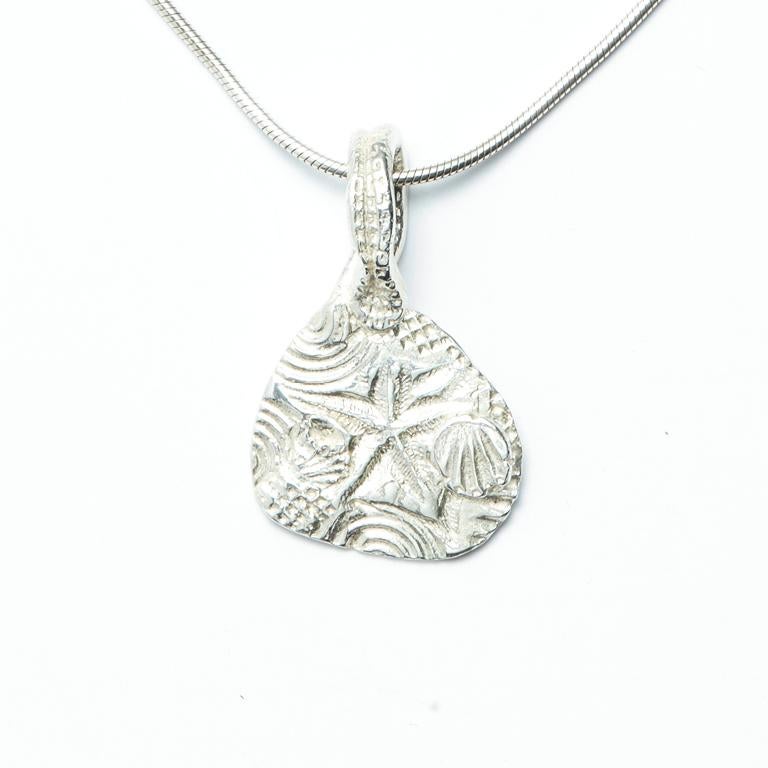 One of our most popular designs, this Sterling Silver pendant features an original seascape-inspired design.

Also available in 18kt Gold, as pictured in styled photos for scale. 

Chain sold separately.