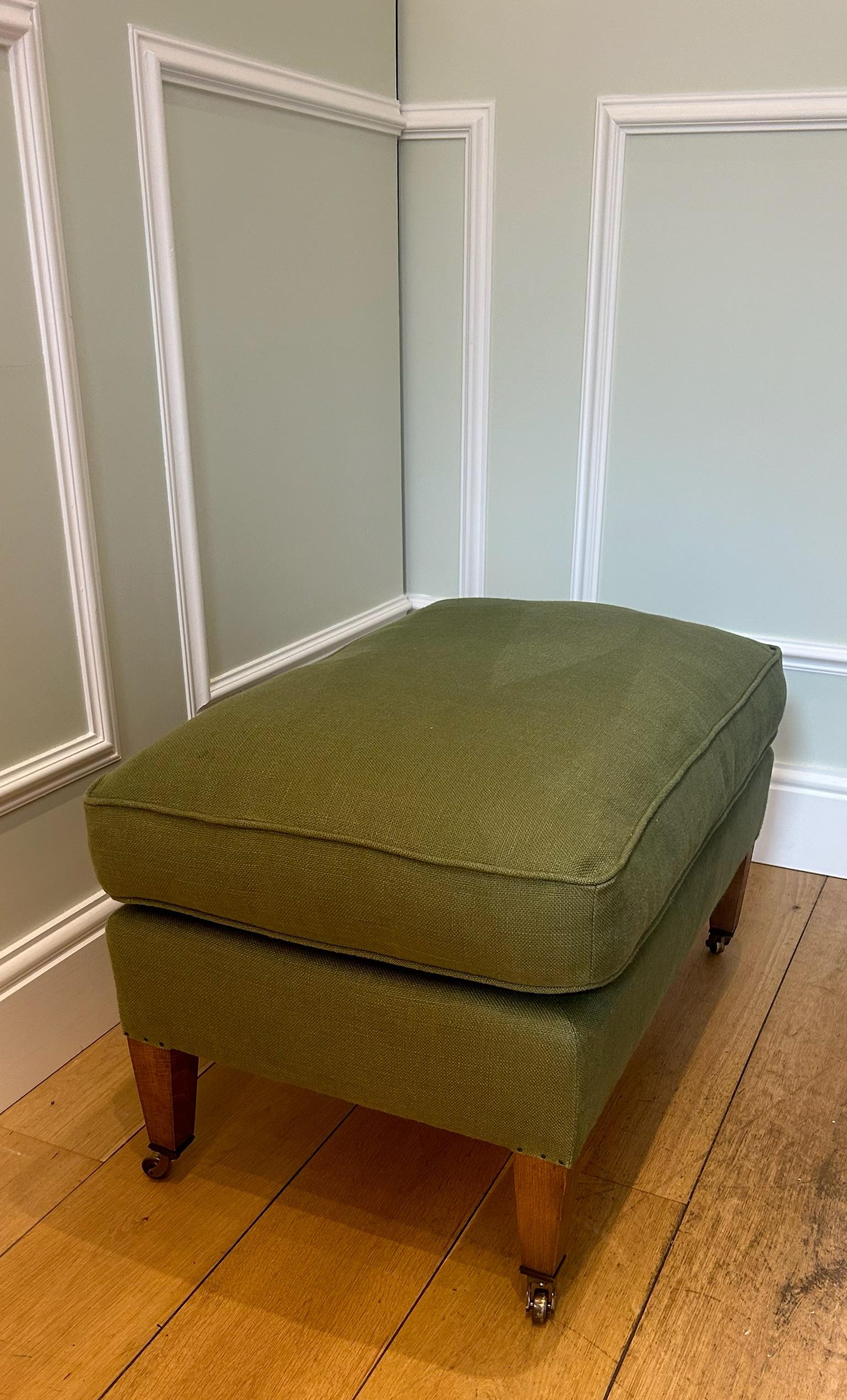 A contemporary footstool inspired by the Howard & Sons Bridgewater model, upholstered in green linen to pair with the matching armchair. Traditional 'siege de duvet' upholstery methods, natural fibre fillings, and a down-wrapped cushion offer