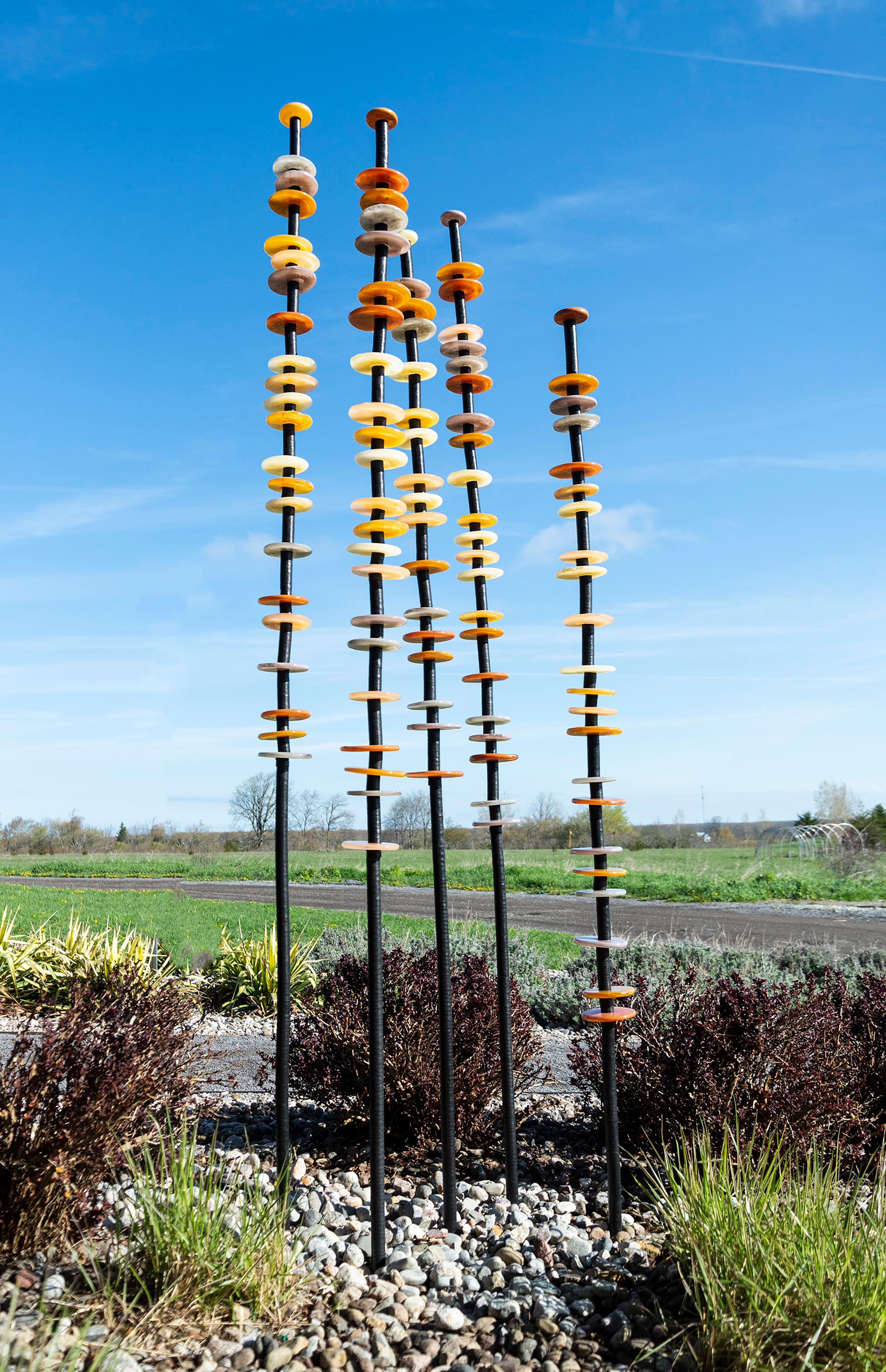 Like flowers in a garden, Susan Rankin’s beautiful glass columns appear to sway in the breeze. An avid gardener, Rankin has created a series of outdoor sculptures inspired by the forms and colours found in nature. These five steel columns feature