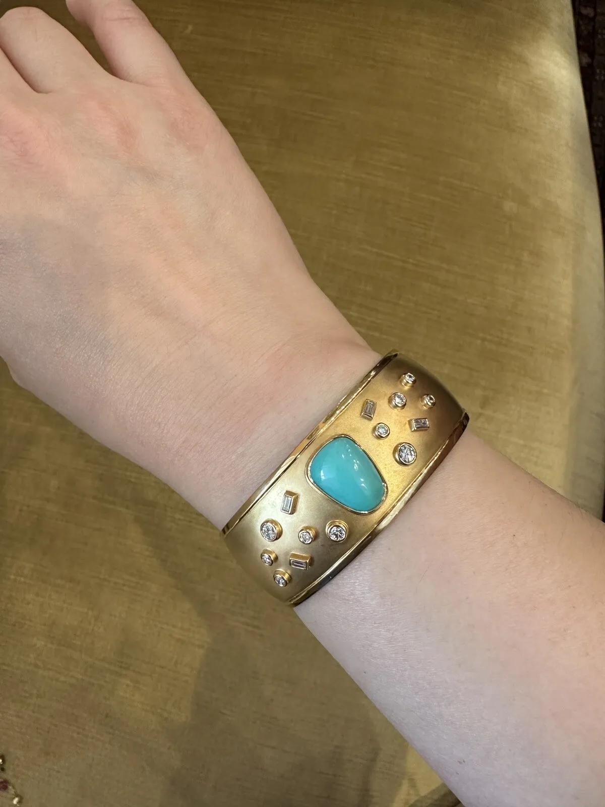 Susan Sadler Turquoise and Diamond Cuff Bracelet in 18k Yellow Gold

Susan Sadler Turquoise and Diamond Cuff features a centerpiece of Natural Turquoise with Round and Baguette Diamonds bezel-set on an 18k Yellow Gold Cuff Bracelet with a