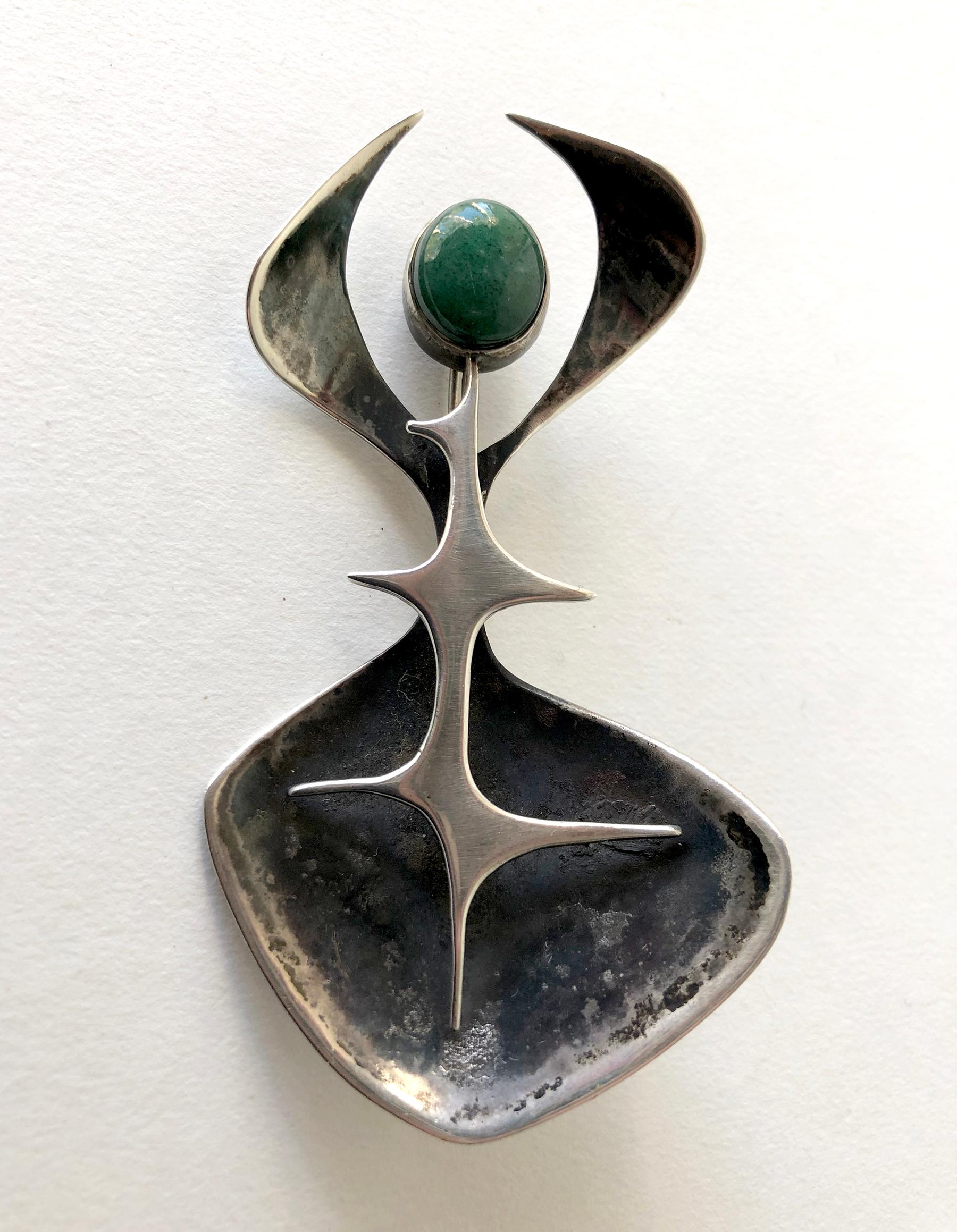 Rare 1950's sterling silver abstract modern brooch featuring an aventurine cabochon created by jeweler Susan Saunders Cook of Canandaigua, New York.  Brooch measures 3 5/8