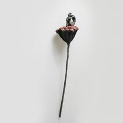 Flora - contemporary bronze wall sculpture of sitting female on red flower stem