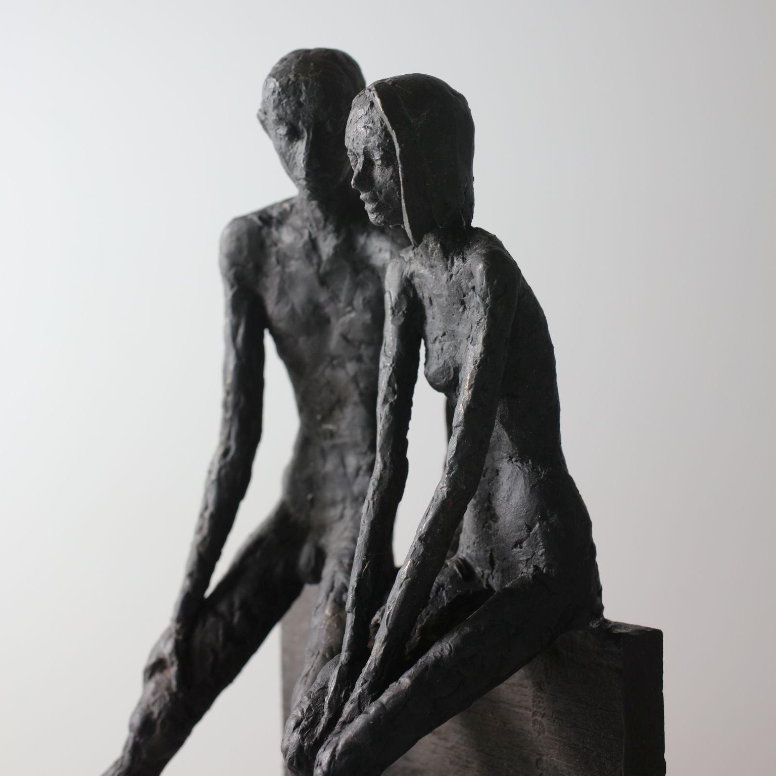 Unity - contemporary bronze sculpture of a nude couple sitting on a bronze block