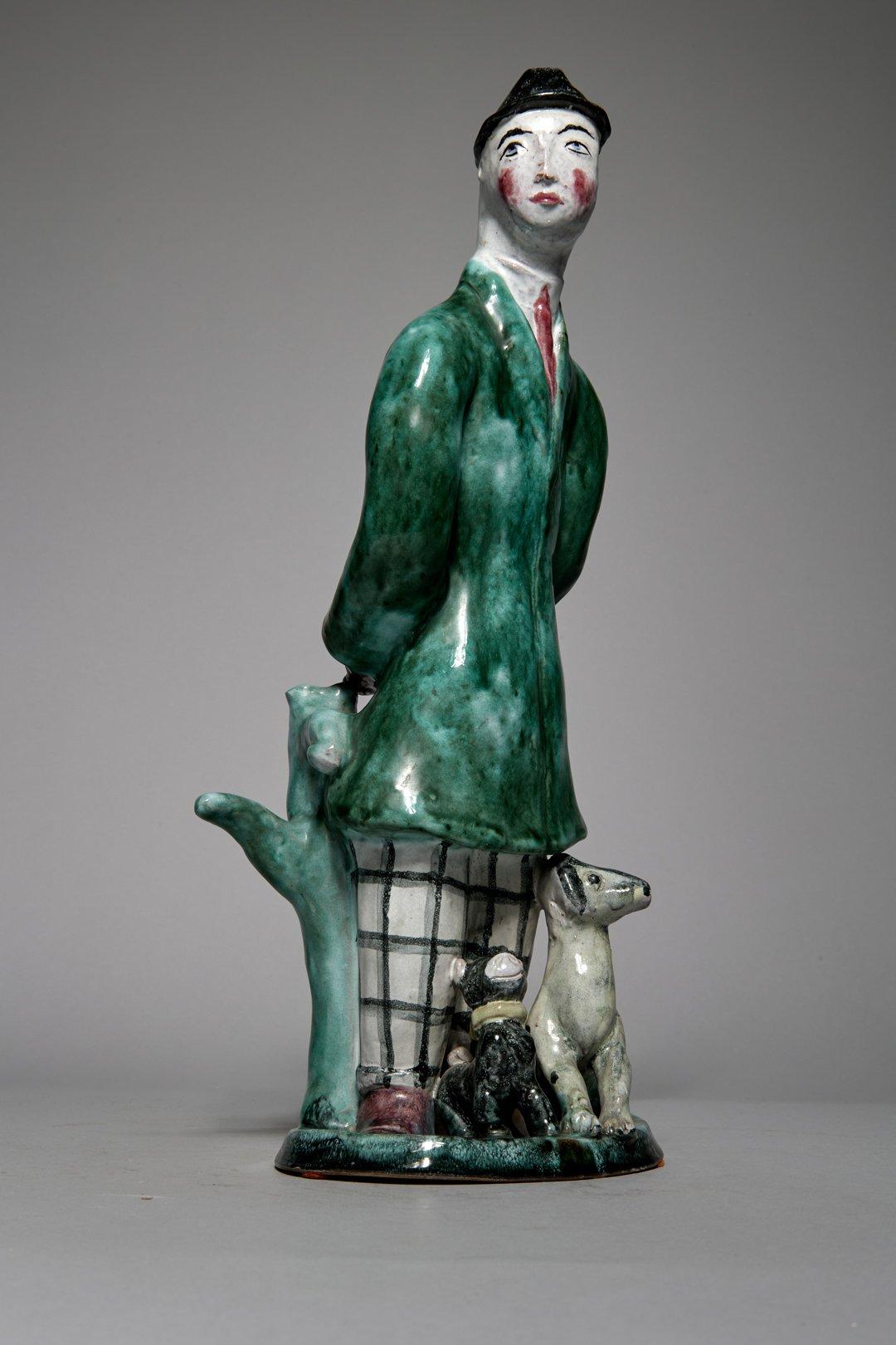 Susi Singer-Schinnerl (Austrian-American, 1891-1965) 
Man with Two Dogs, c. 1925
Ceramic
Manufactured by the Wiener Werkstätte, model number 682
Stamped on bottom
13 x 5.5 x 4 inches

Susi Singer, also known as Selma Singer-Schinnerl, was an