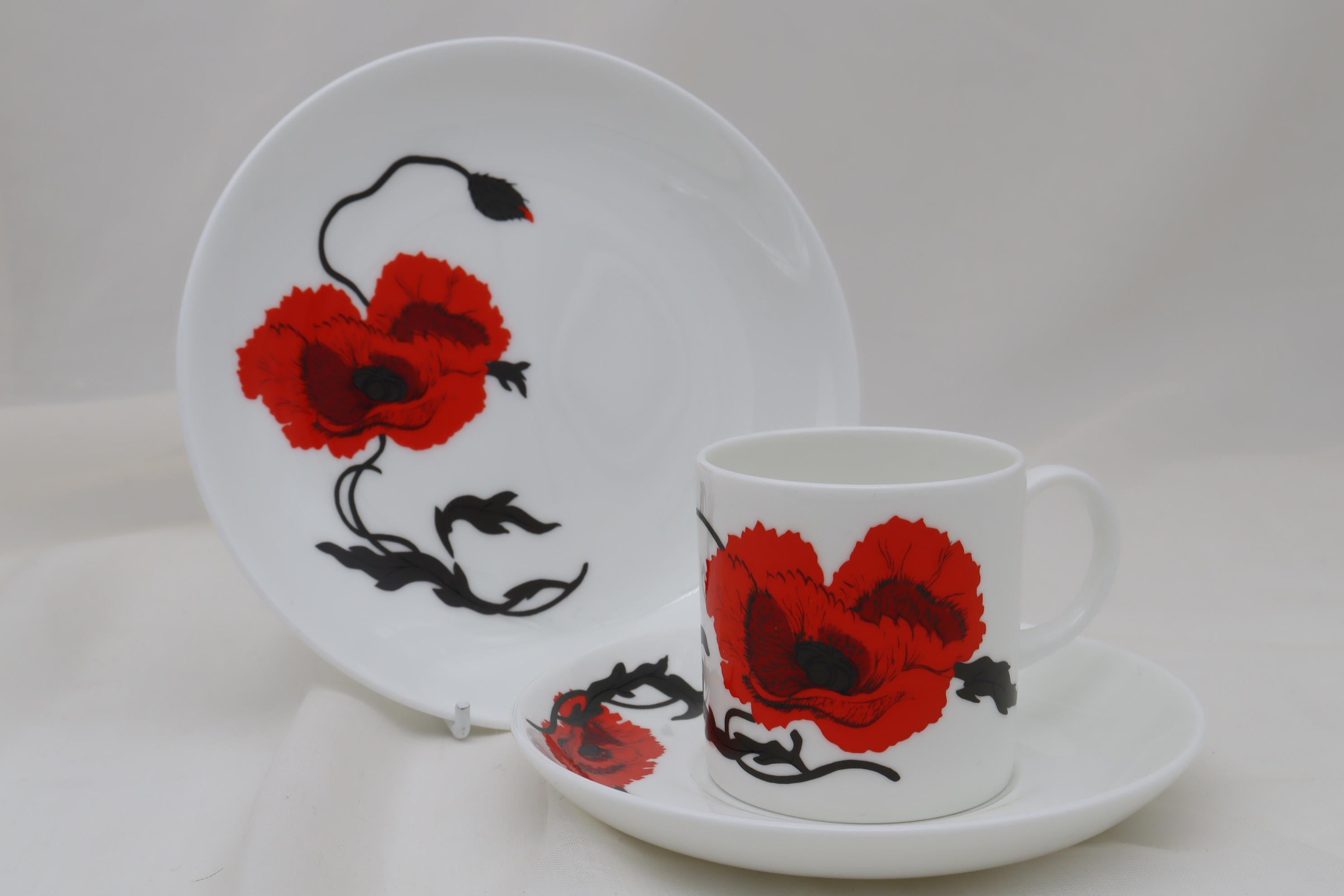 This bone china Susie Cooper coffee set is decorated with the popular Cornpoppy pattern on the Can shape. The Cornpoppy pattern (pattern C 2176) was introduced in 1971 and became one of Wedgwood's most successful lines of the late 1970's through to
