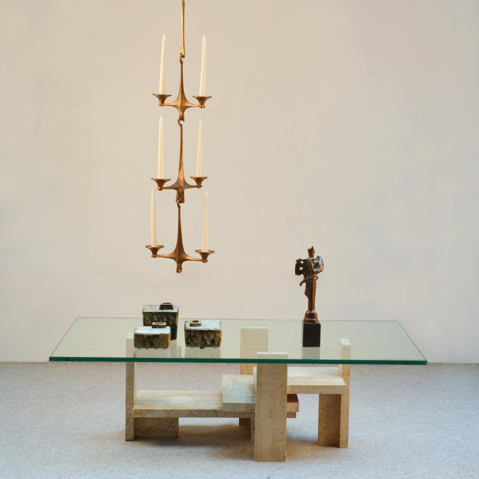 Hanging bronze cast candelabra composed of 3 arms each holding two regular candles, suspended from bronze interlocking extensions each 24 cm long and a bronze hook to be hung from the ceiling' designed by Michael Harjes and produced by Harjes