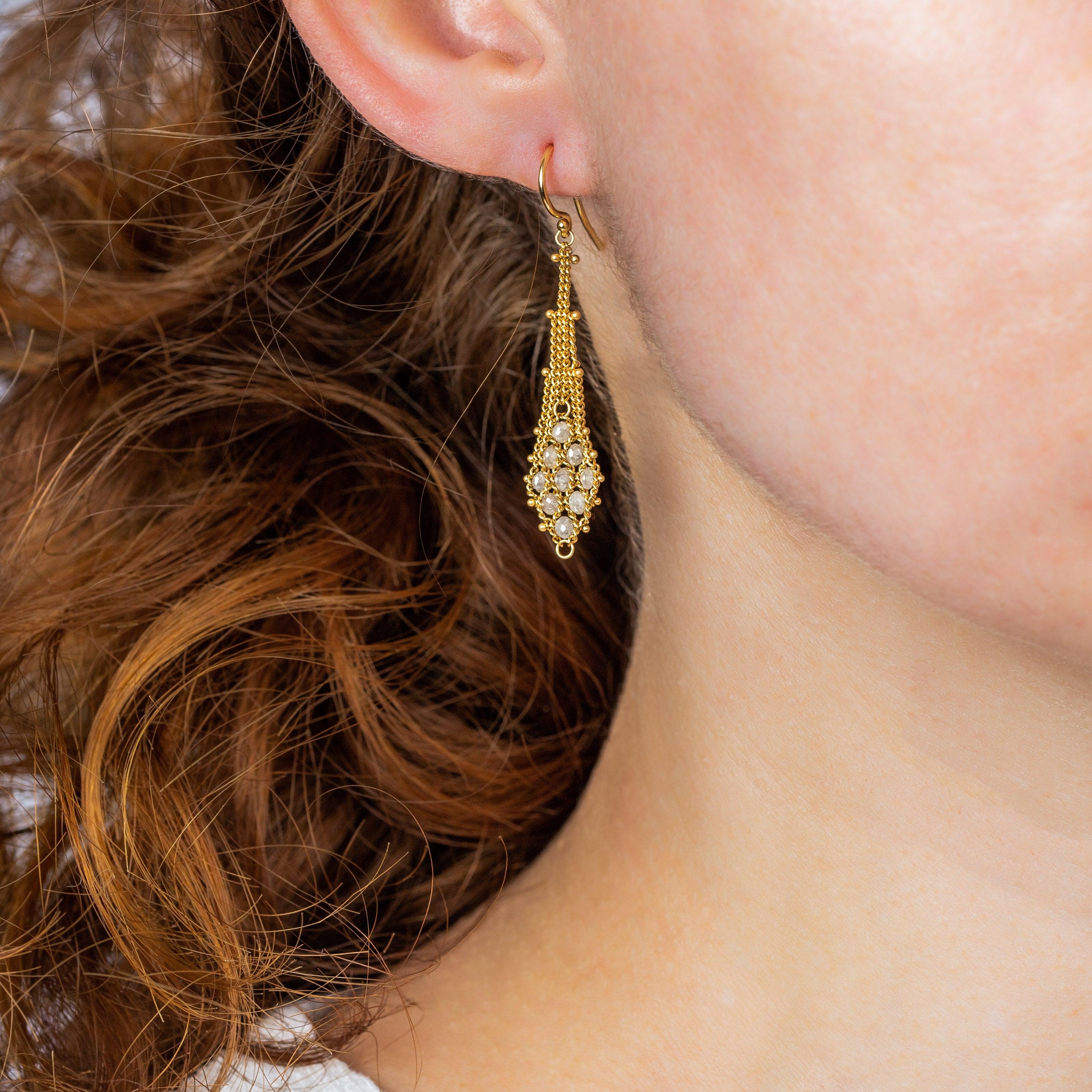 These earrings begin with a suspended trellis of meticulously hand-woven 18K yellow gold chains. The buttery web of lush gold strands widens into a gold kite shape that is seeded throughout with ethereal Pearls. The effect is elegant and sensual, an
