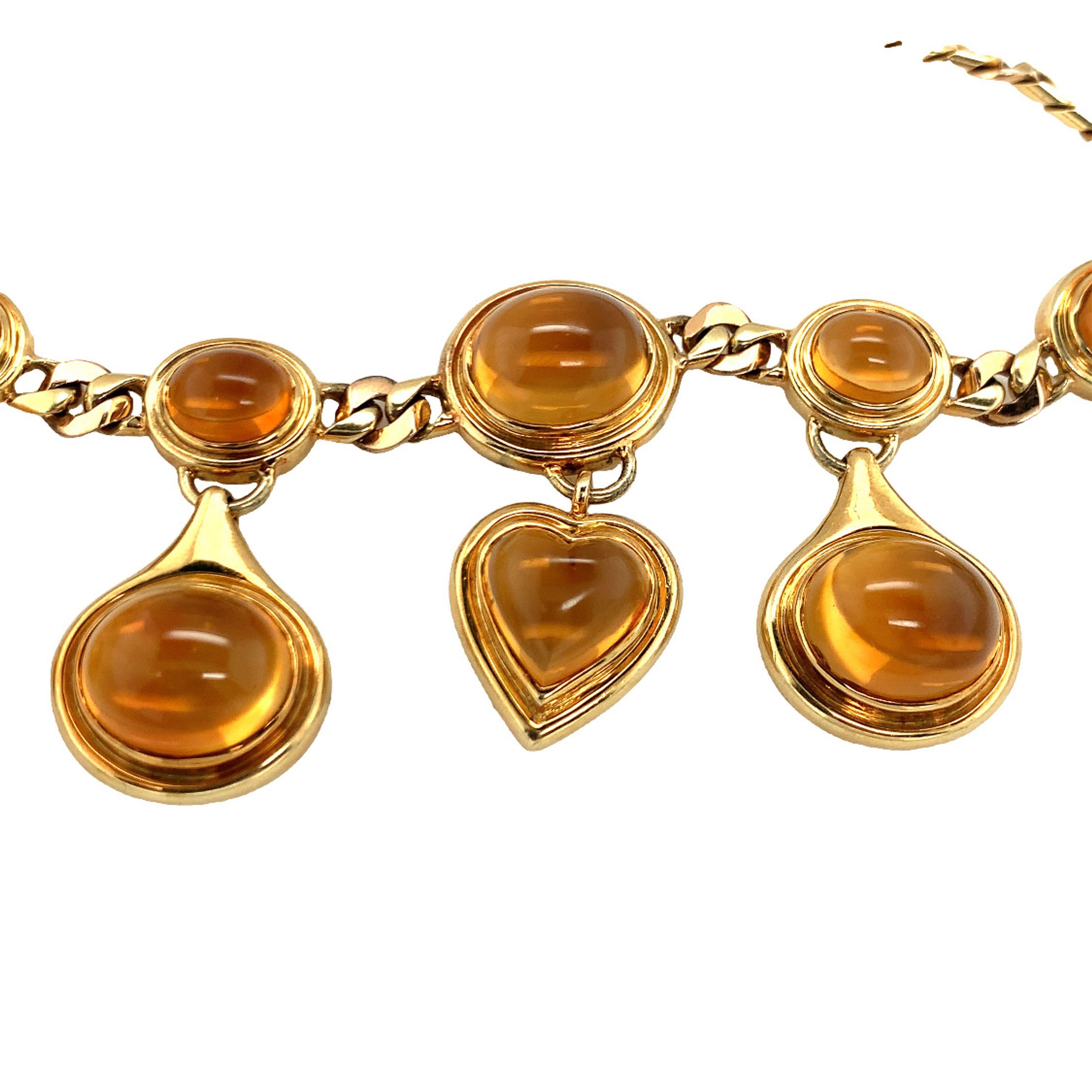 One citrine 18K yellow gold necklace composed of ten bezel set, oval and heart cabochon cut suspended citrines totaling 120 ct. upon a bi-color gold curb link chain necklace. Italian hallmarks.

Extravagant, regal, bold.

Metal: 18K yellow