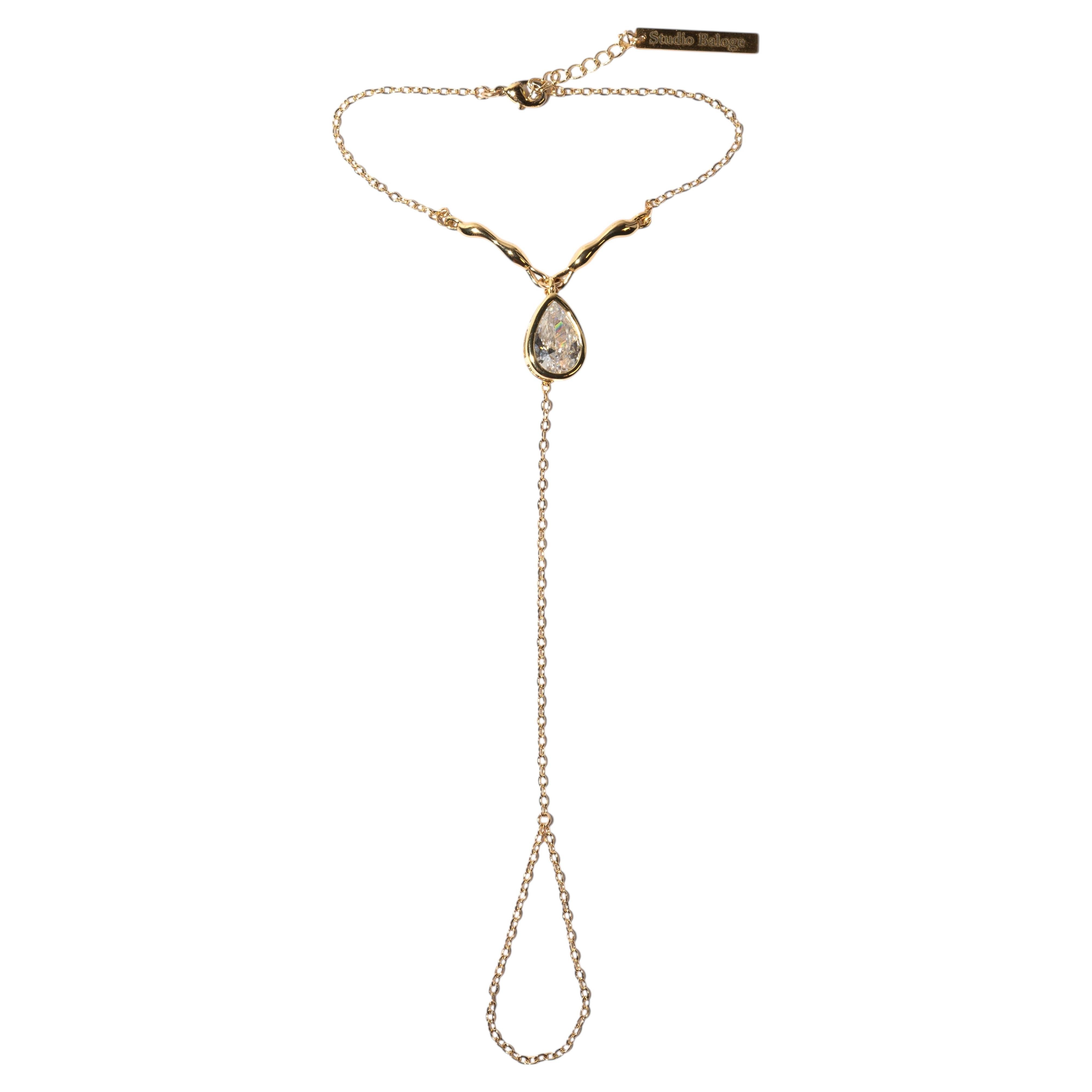 Cadena de mano Suspendue Goutte de oro de 14 quilates con gota de cristal talla pera