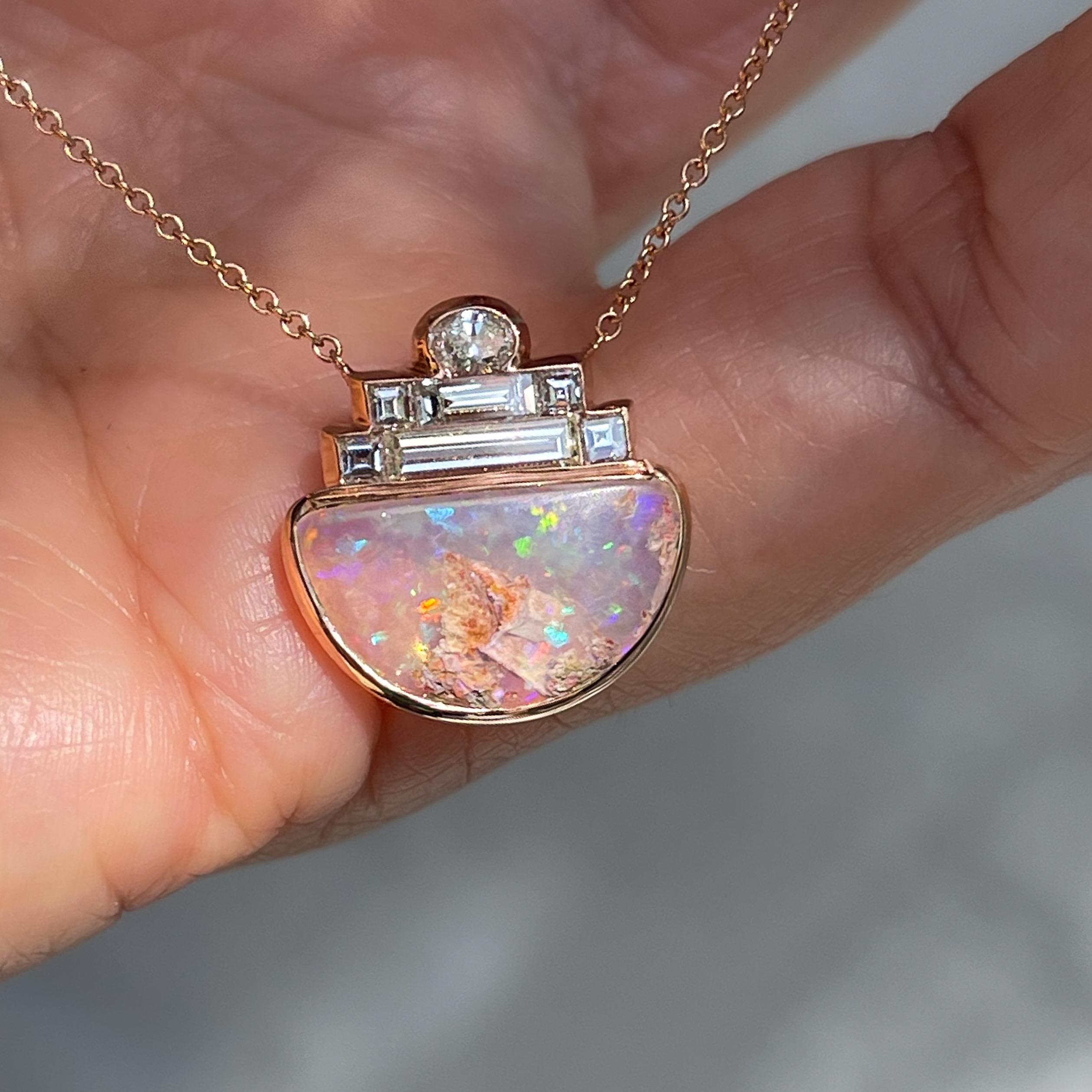 Art deco elegance meets prismatic allure in this Australian Opal Necklace. A tiny oval and six baguette diamonds cascade toward a crystal opal. Suspended by a rose gold chain, the opal and diamond necklace has a seamless essence, resulting from the