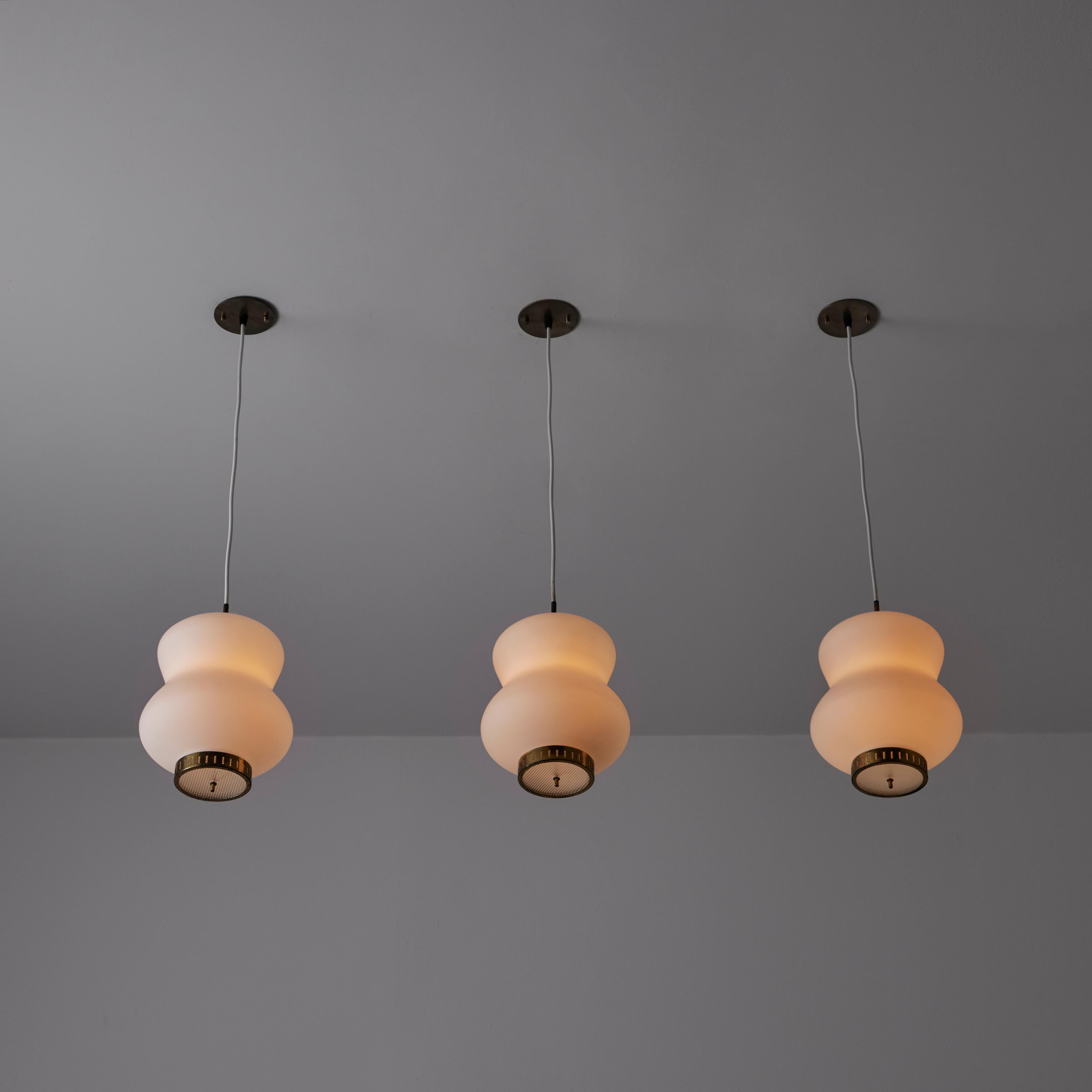 Suspension ceiling light by Stilnovo. Designed and manufactured in Italy, circa the 1960s. A trio of bentwood armatures hoists three large blown opal glass bodies. The main glass shades are sandblasted opal white, paired with a reeded glass bottom