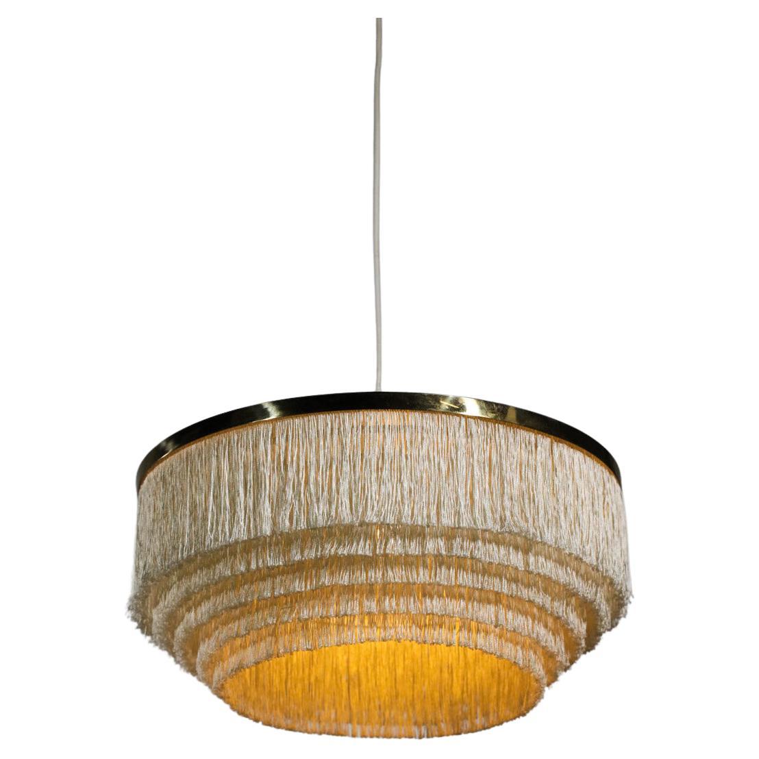 Large Scandinavian suspension lamp model T603 by the famous Swedish designer Hans Agne Jakobsson from the 60s. Solid brass structure and attachment, off-white silk fringe diffuser, very nice vintage condition with a nice patina on the brass (see