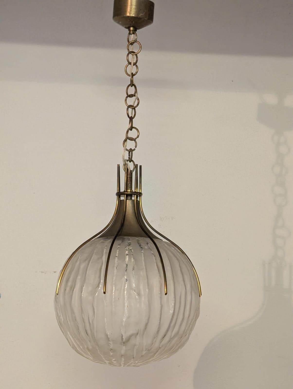 The ceiling light was created by famous Italian artist and designer Angelo Brotto, and produced by Italian lighting company Esperia in the 50s. The lamp is made from brass and cut satin acid-etched glass. It is 47 cm high. But with the brass chain