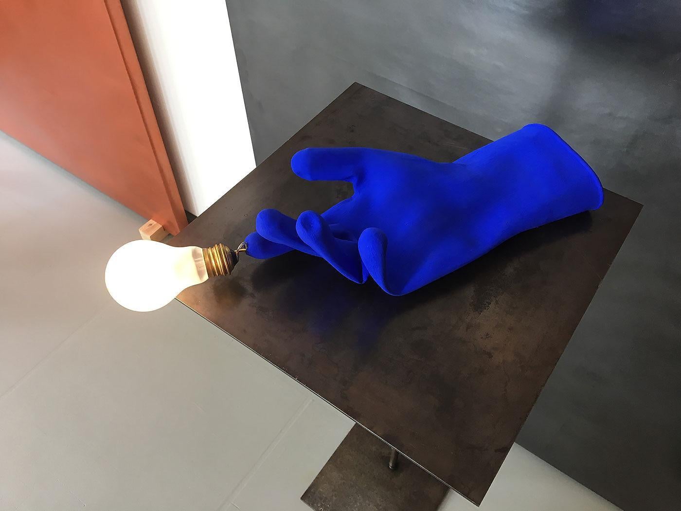 Brand: Ingo Maurer
Model: Luzy
Designer: Ingo Maurer

Luzy is one of Ingo Maurer’s most surprising and unconventional creations — a blue glove transformed into a pendant lamp, with a frosted bulb placed at the tip of the pointing finger. Playful,