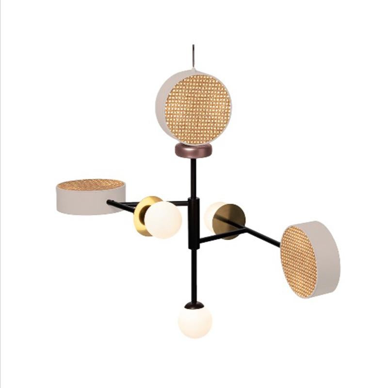 Monaco is a perfect suspension of round shapes, rattan mesh, wooden detail and brass details intertwined with delicate and opal glass globes. 
The structure and the cylinders are finished in a smooth, homogeneous powder coating layer. The brass