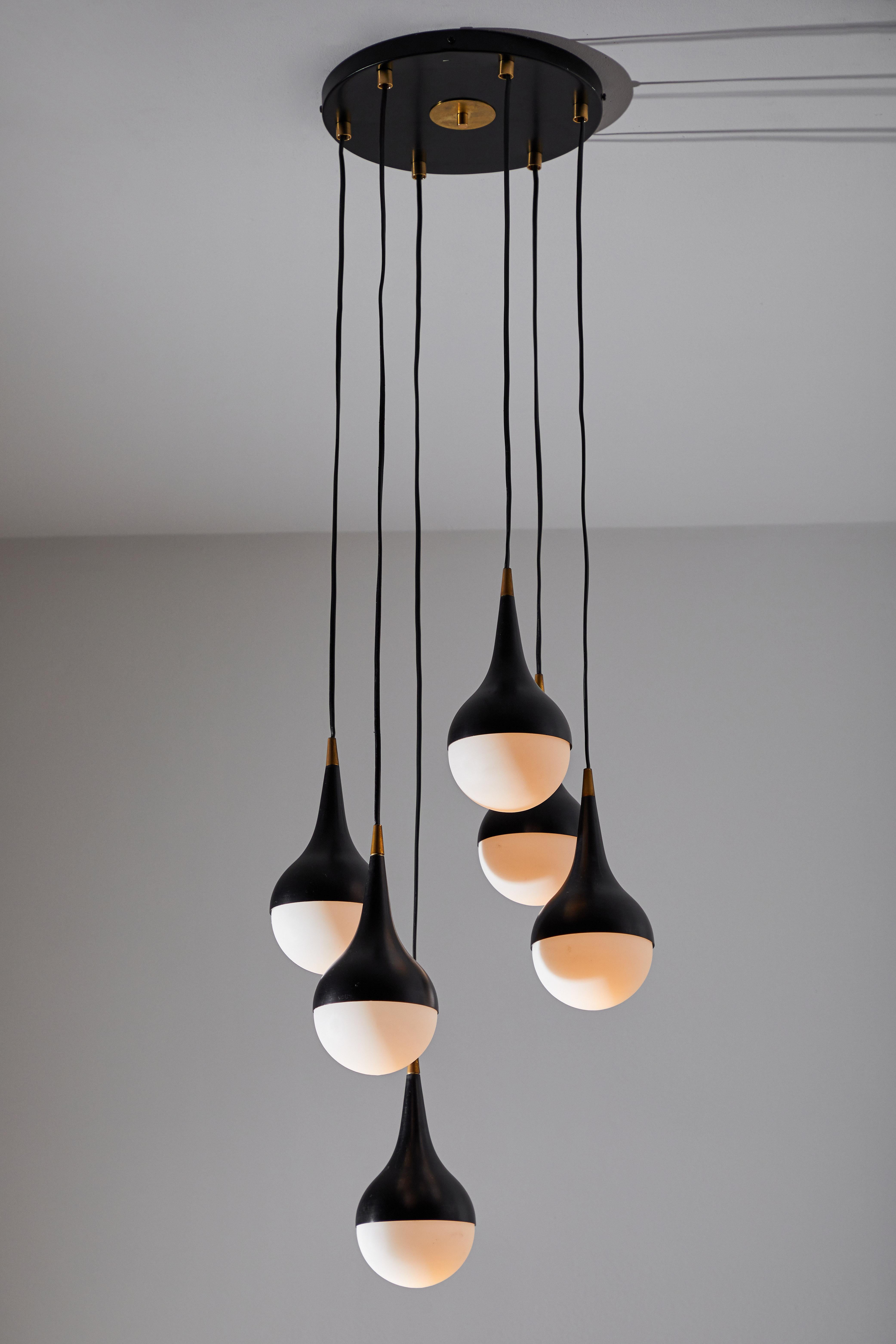 Suspension light by Stilnovo. Manufactured in Italy, circa 1960s. Enameled aluminum, brass hardware, brushed satin glass diffusers. Retains original manufacturer's label. Takes six E27 25 W maximum candelabra bulbs. Bulbs provided as a one time