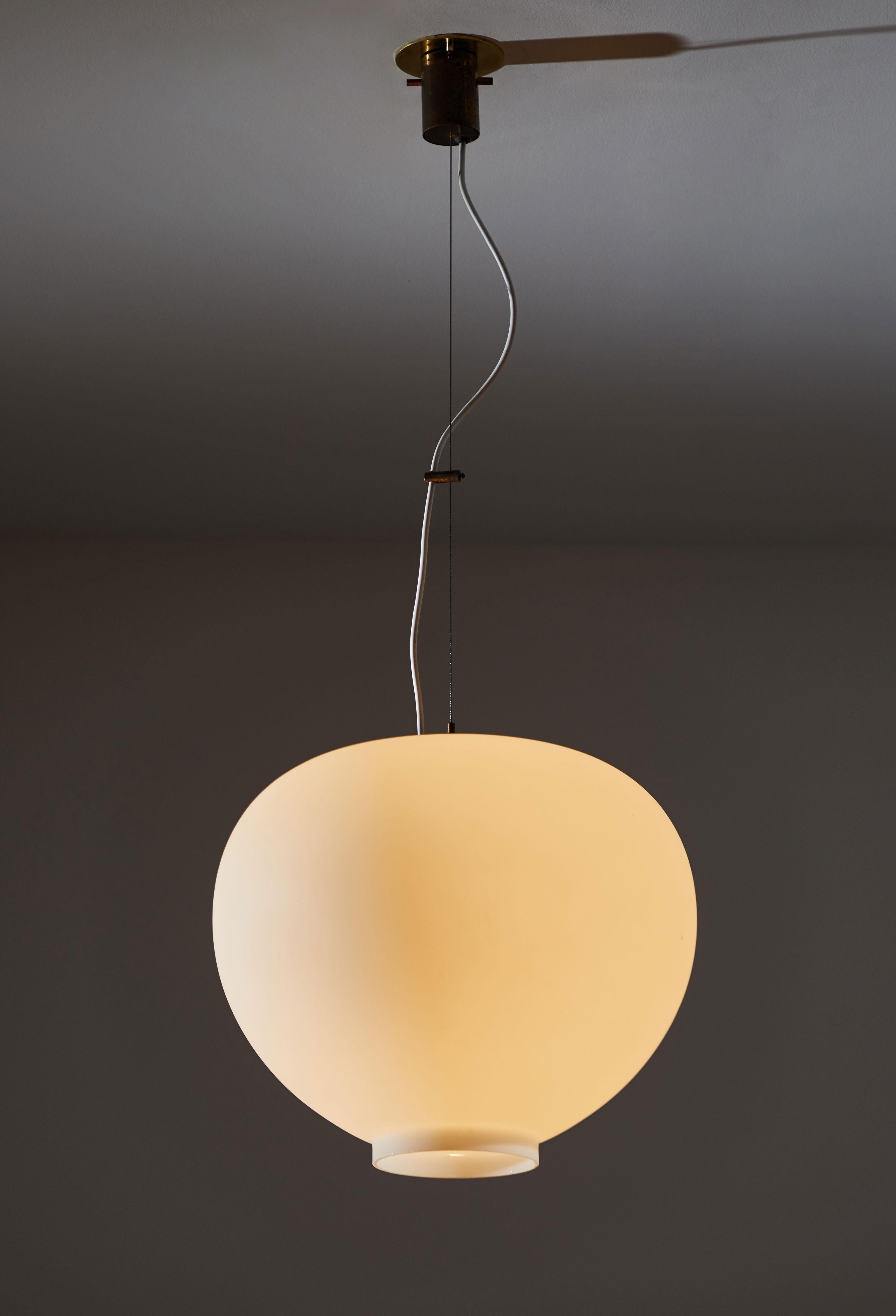 Suspension light by Stilnovo. Manufactured in Italy, circa 1950s. Brushed satin glass diffuser, brass hardware. Custom brass ceiling plate. Original canopy. Rewired for US junction boxes. Maintains original manufacturer's label. Takes one E27 100w