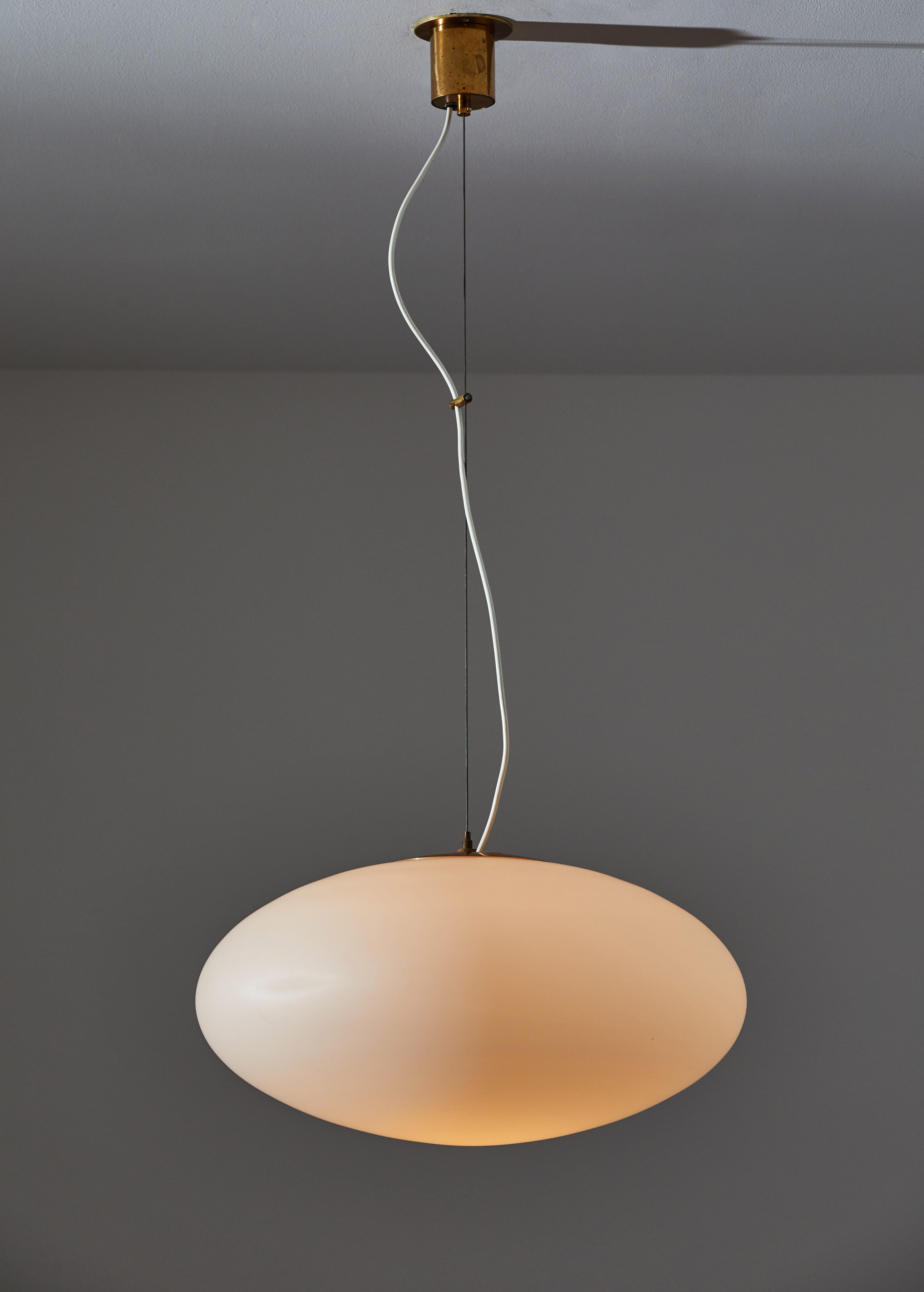 Suspension light by Stilnovo manufactured in Italy, circa 1950s. Brushed satin glass with brass hardware. Original canopy. Custom brass backplates. Rewired for US junction boxes. Overall drop can be customized. Takes one E27 100W maximum bulb. Bulbs