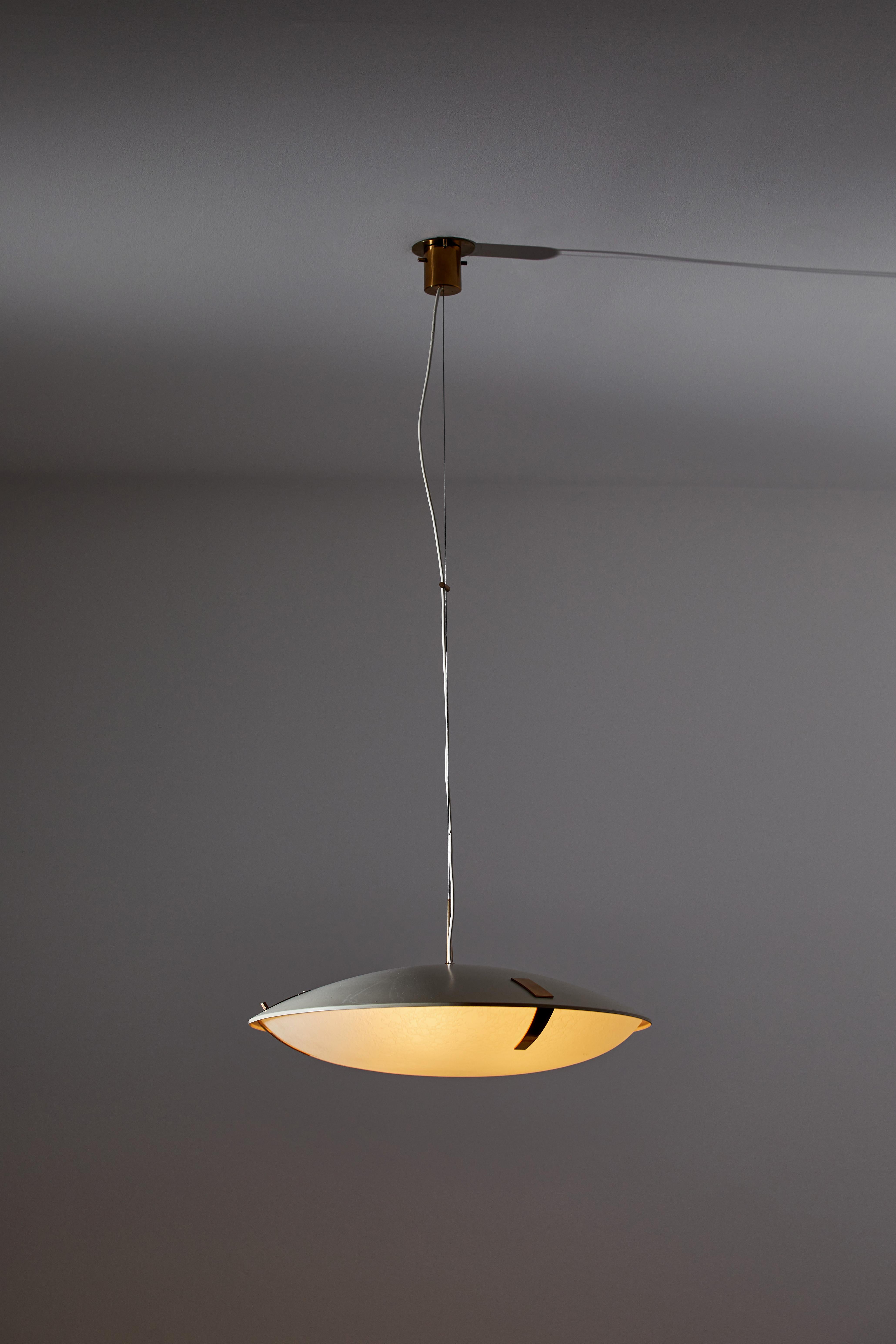 Suspension light by Stilnovo. Manufactured in Italy, circa 1960s. Enameled metal, textured glass diffuser, brass accents. Rewired for U.S. standards. Original canopy, custom brass ceiling plates. We recommend three E26 100w maximum bulbs. Bulbs