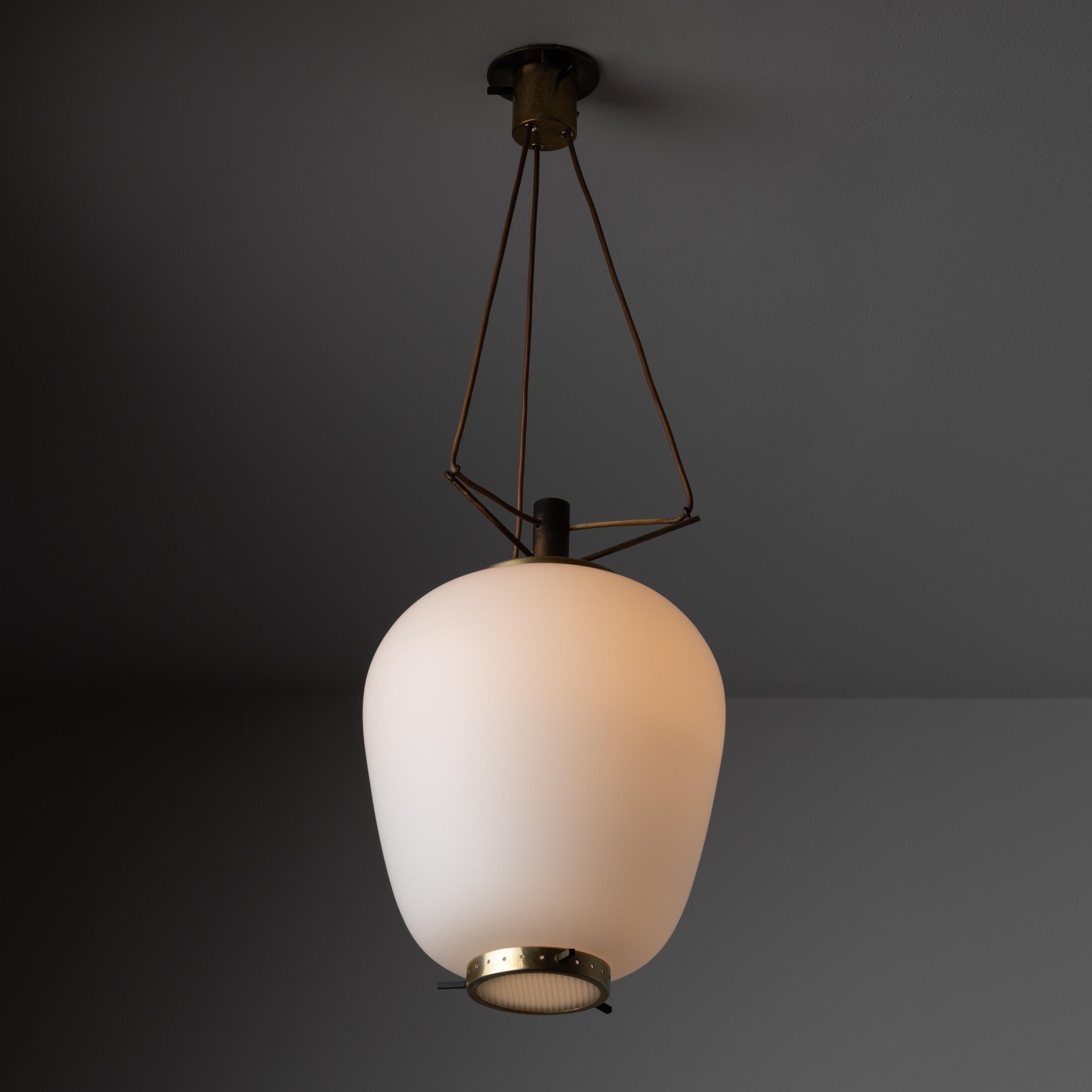 Suspension Light by Stilnovo. Manufactured in Italy, circa the 1950s. Features a large frosted glass shade paired with a reeded glass bottom diffuser cap. Polished brass and painted black hardware. Rewired for U.S. standards. Original canopy, custom