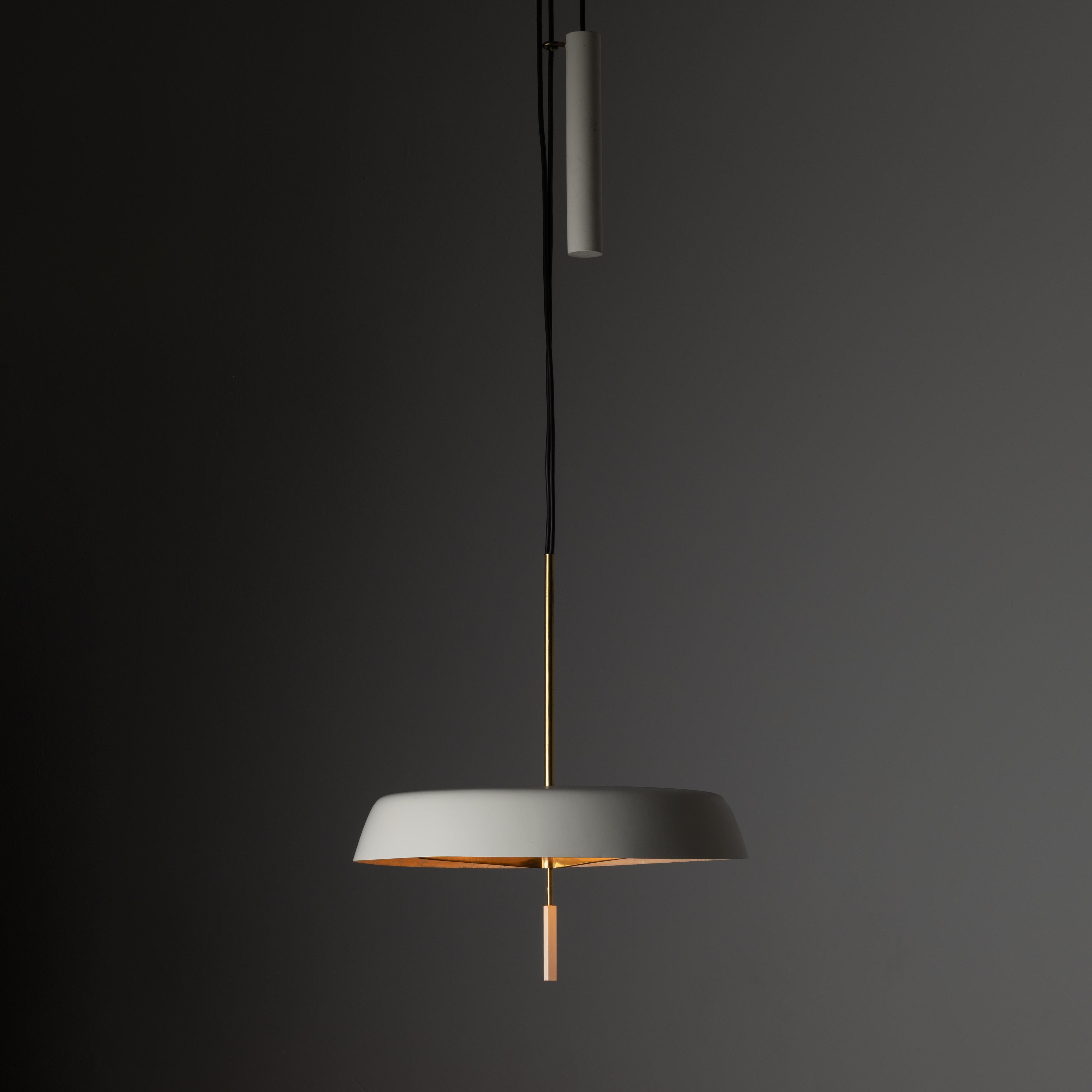 Suspension Light by Stilnovo. Designed and manufactured in Italy, circa the 1950s. A pulley system suspension ceiling light allows for height adjustment. The shade and bottom finial are an off-white, bone colored enameled finish. The bottom diffuser