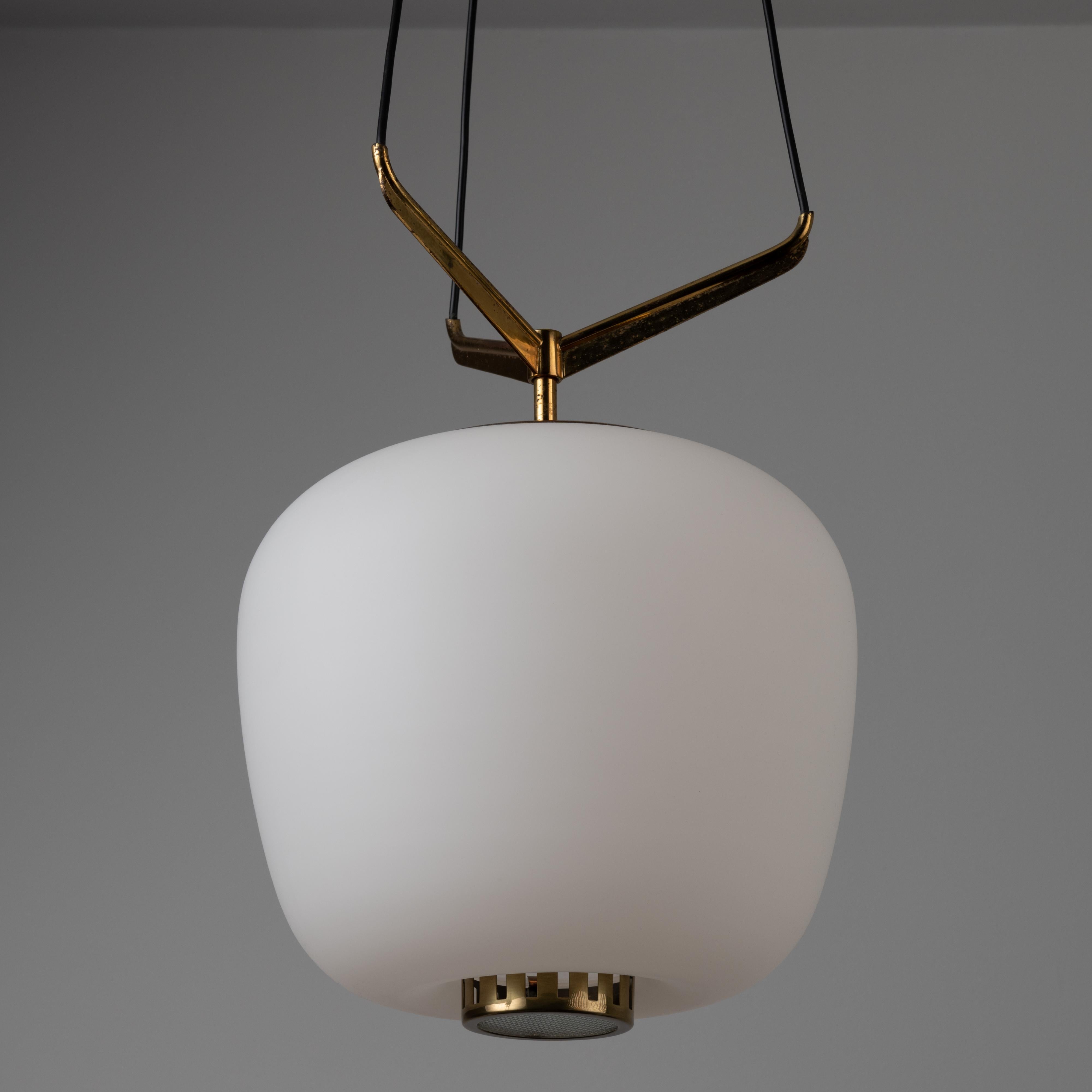 Suspension light by Stilnovo. Manufactured in Italy, circa the 1950s. Features a large frosted glass shade and three brass suspension armatures. Bottom reeded glass diffuser adds a nice detail to this iconic Stilnovo design. Rewired for U.S.